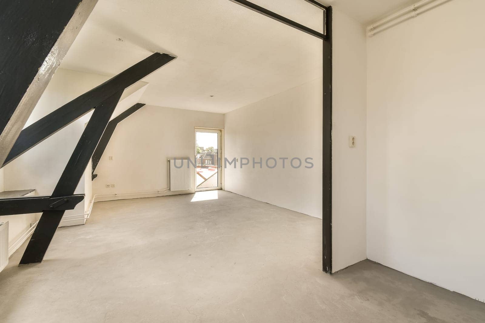 a living room with white walls and a black door by casamedia