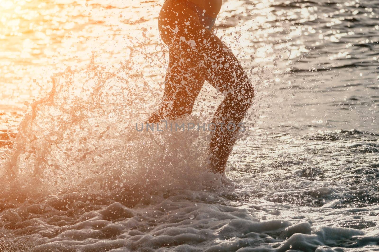 Running woman. Female runner jogging during the sunrise on beach. Woman Runner feet running on the beach at sunrise. woman fitness sunrise jog workout wellness concept.