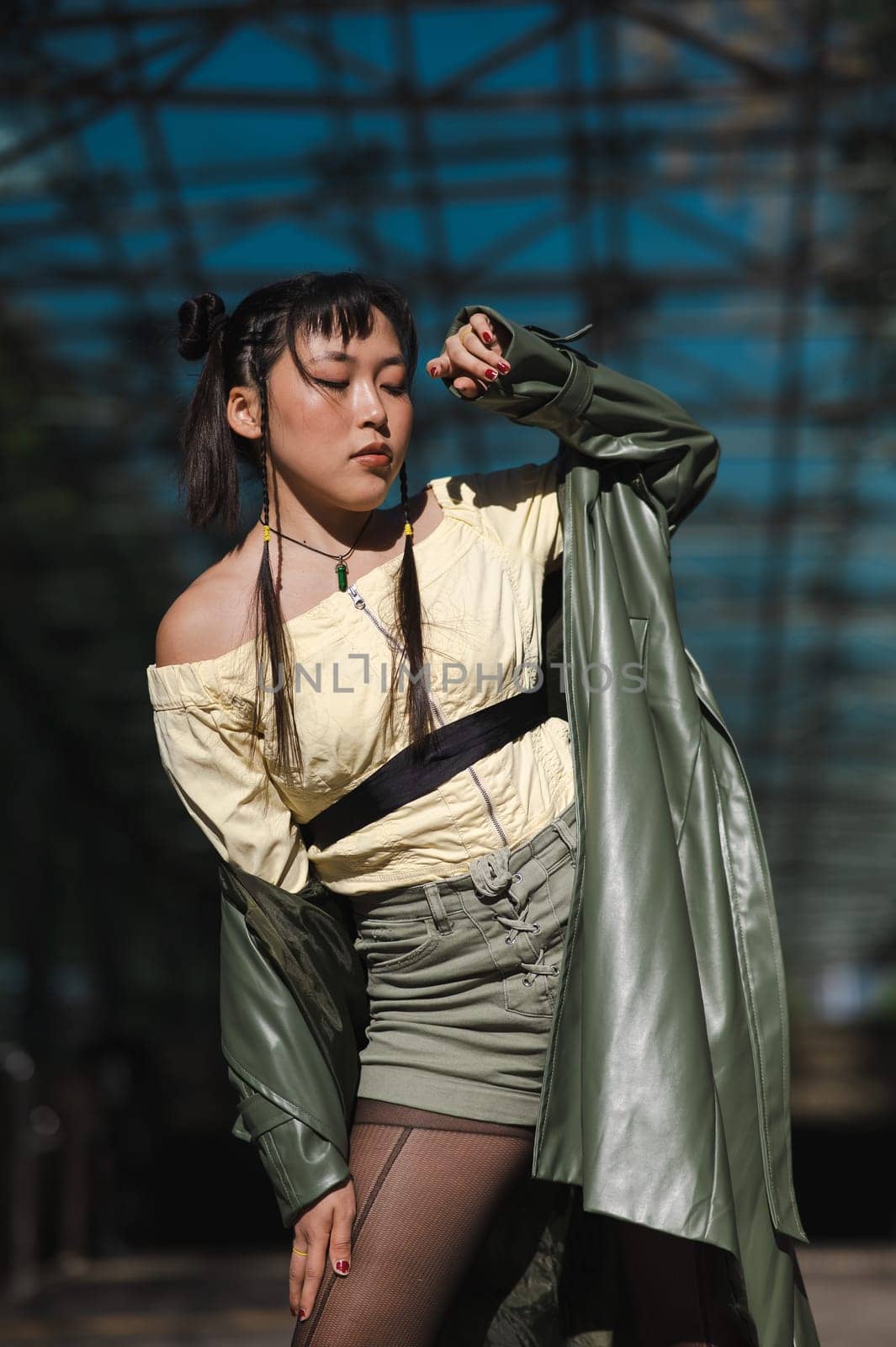 Young Asian woman posing at subway exit