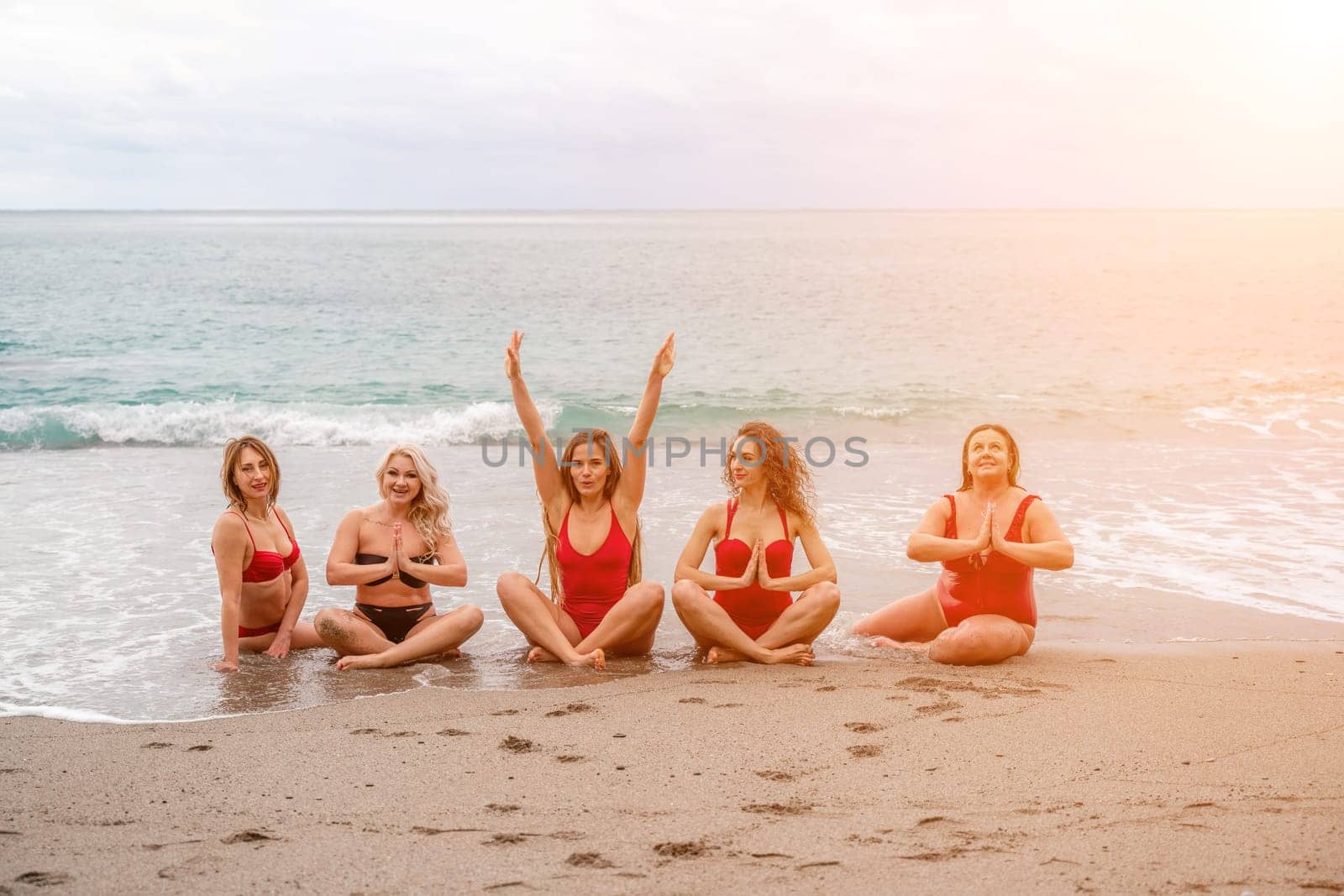 Big happy family or group of five friends is having fun against sunset beach. Beach holidays concept. by Matiunina