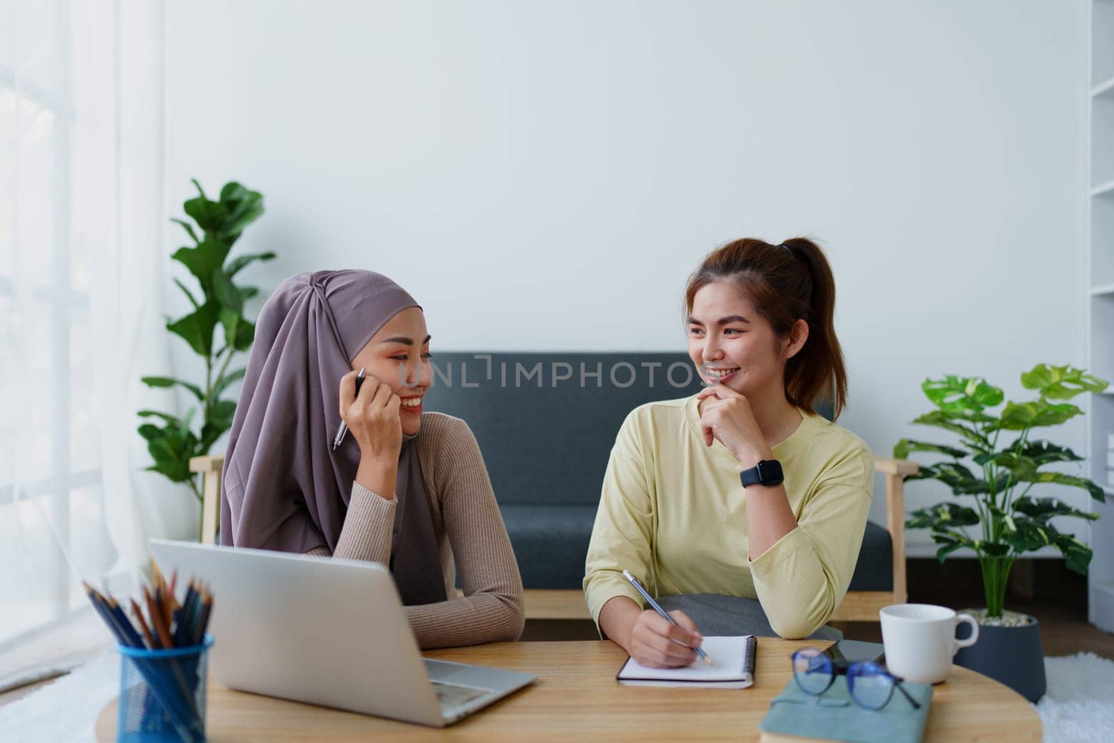 Muslim undergraduates and Asian women are studying online using computers