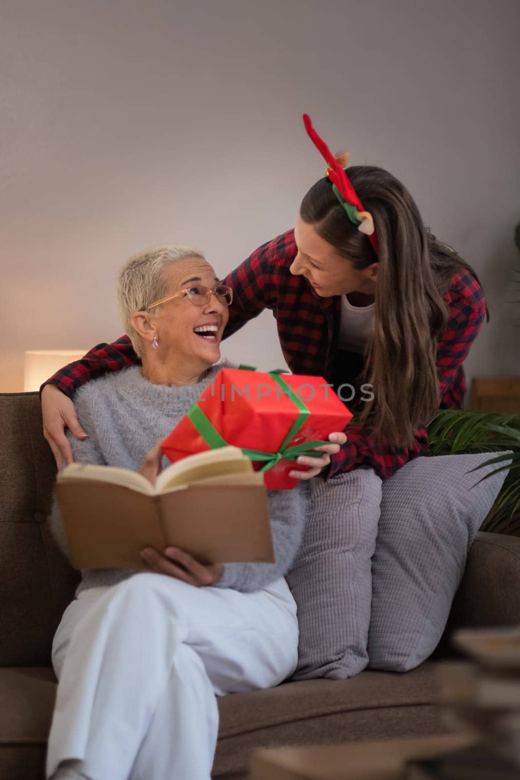 Caucasian Family, winter holiday and concept happy mother and daughter surprise decorating Christmas tree and give a gift at home.