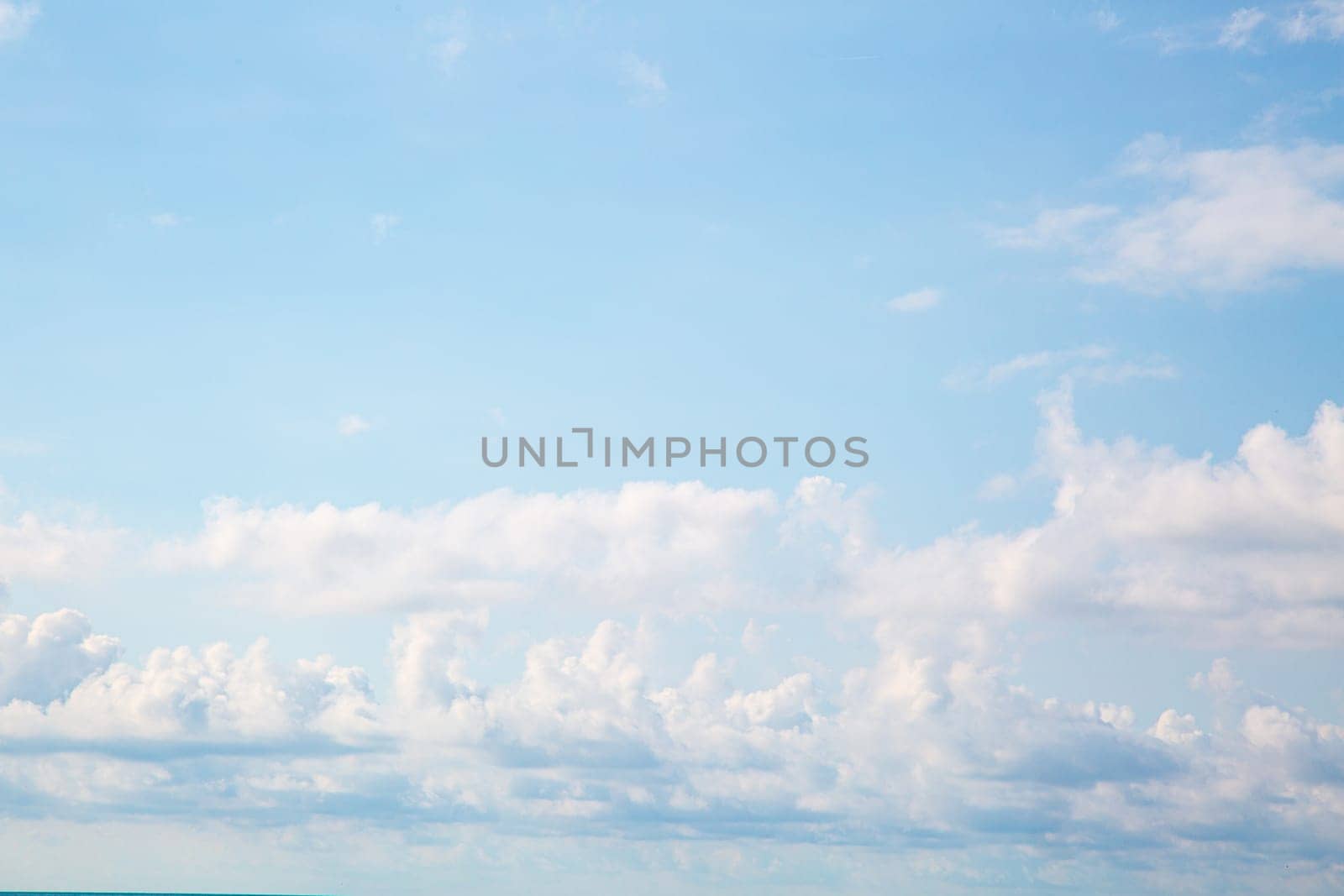 Blue sky background with clouds. Beauty clear cloudy sunshine calm bright texture. Vivid cyan landscape in spring day environment