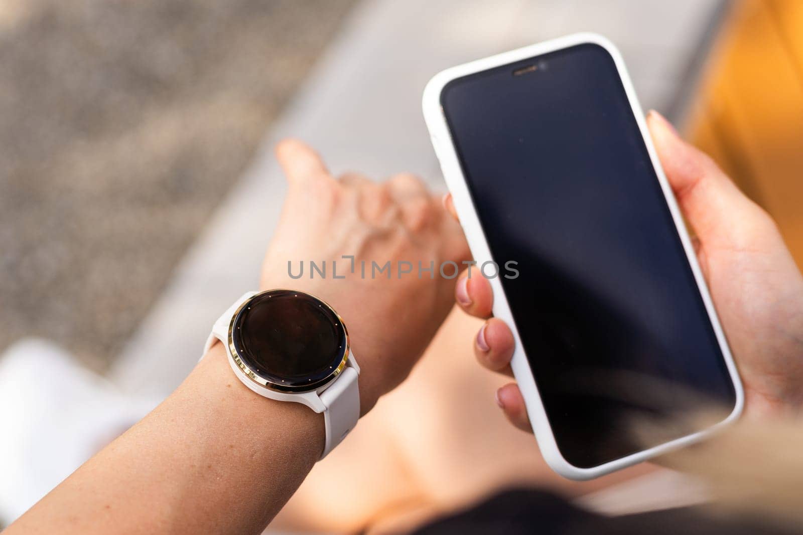 phone in the hands of a girl and a smart watch on her hand mockup. High quality photo