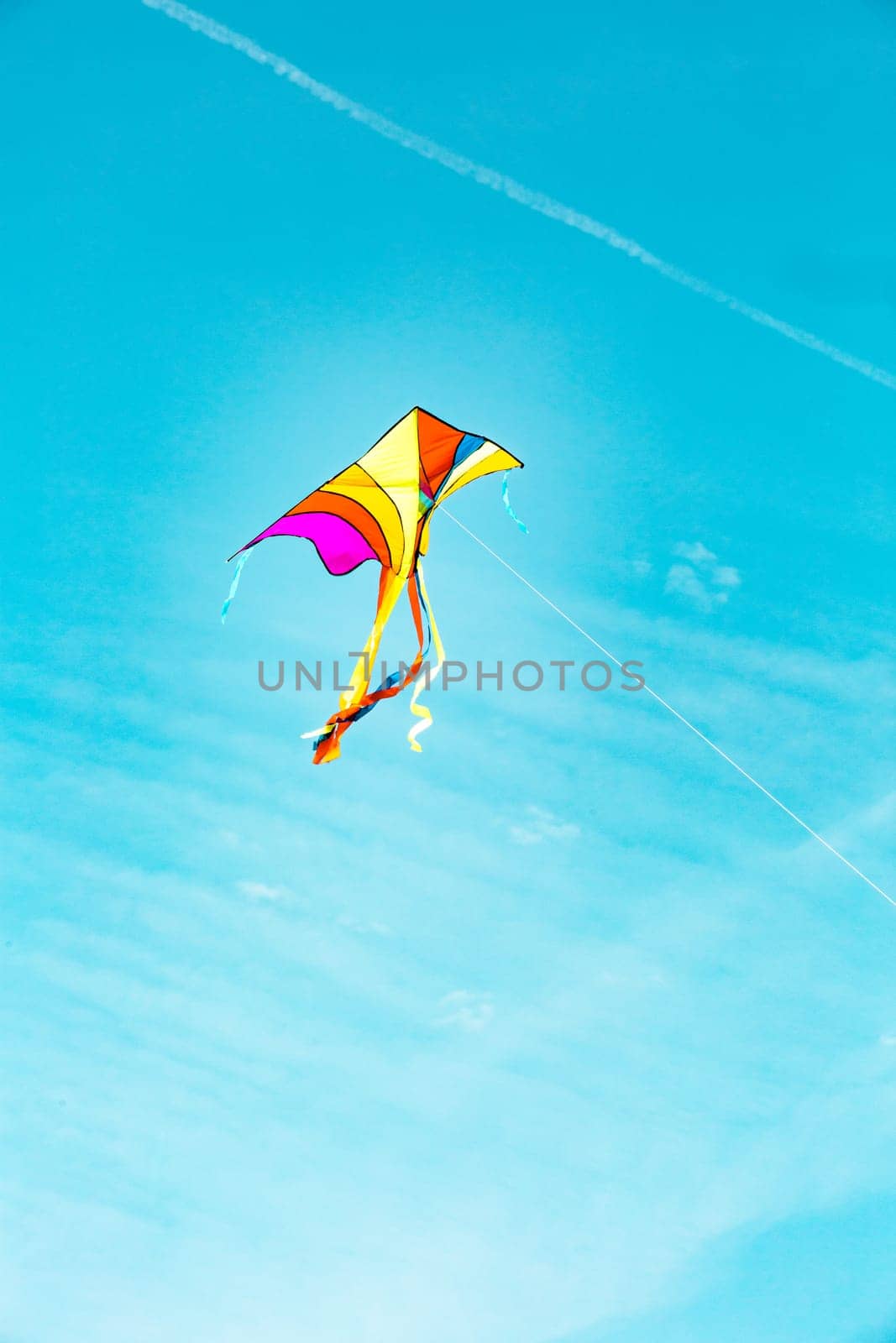 Colorful kite flying freely in the wind by Ciorba