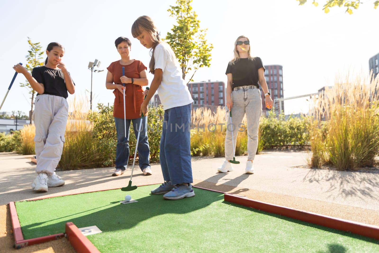 Kids playing golf inside playground artificial grass activity game for children by Andelov13