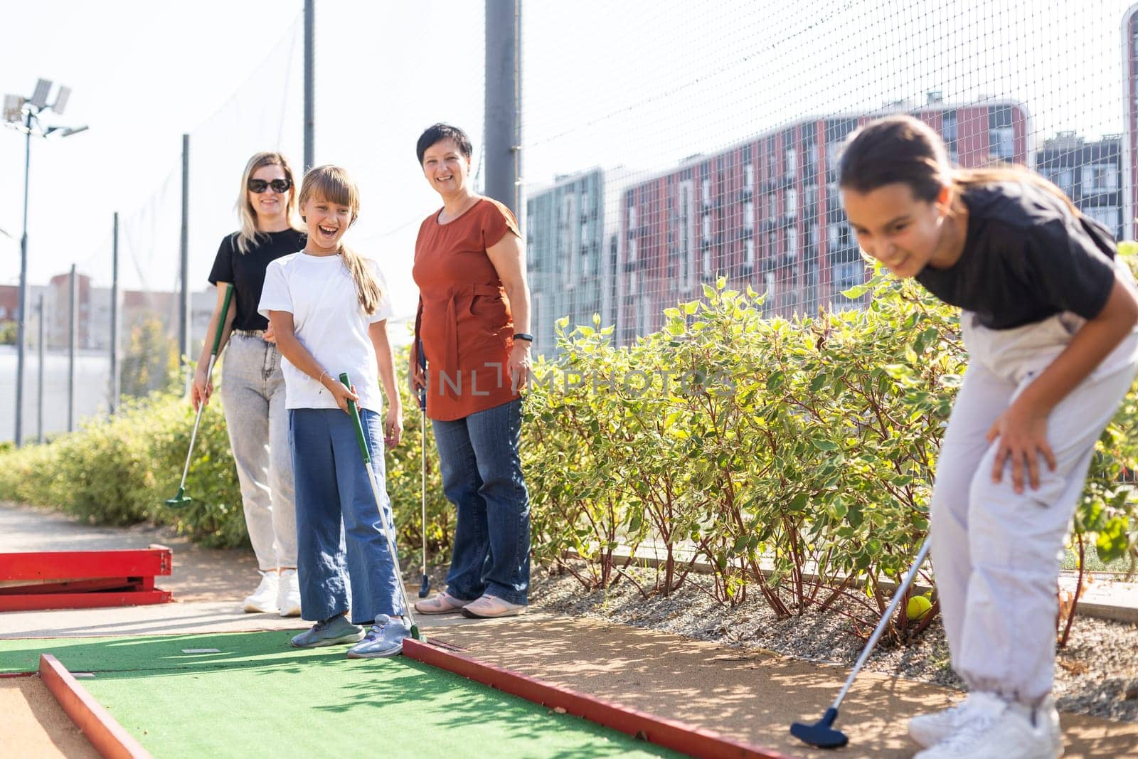 family playing mini golf on a cruise liner. Child having fun with active leisure on vacations. High quality photo