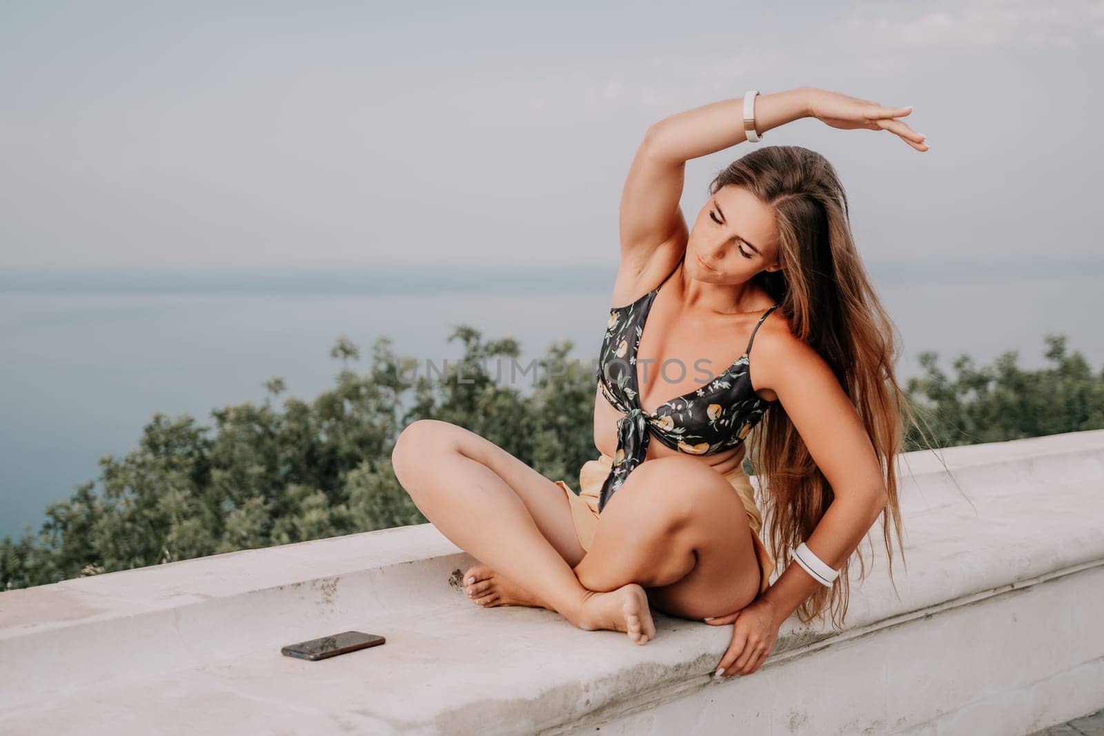 Woman park yoga. Side view of free calm bliss satisfied woman with long hair standing in morning park with yoga position against of sky by the sea. Healthy lifestyle outdoors in park, fitness concept