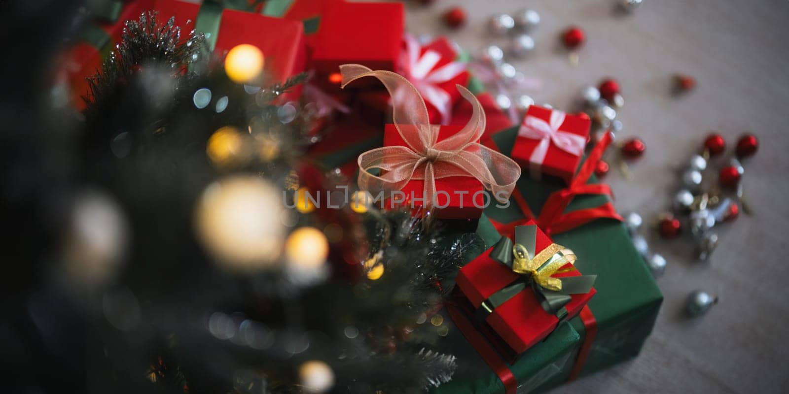Background Christmas Tree and gift box with Decorations Near a Fireplace with Lights.
