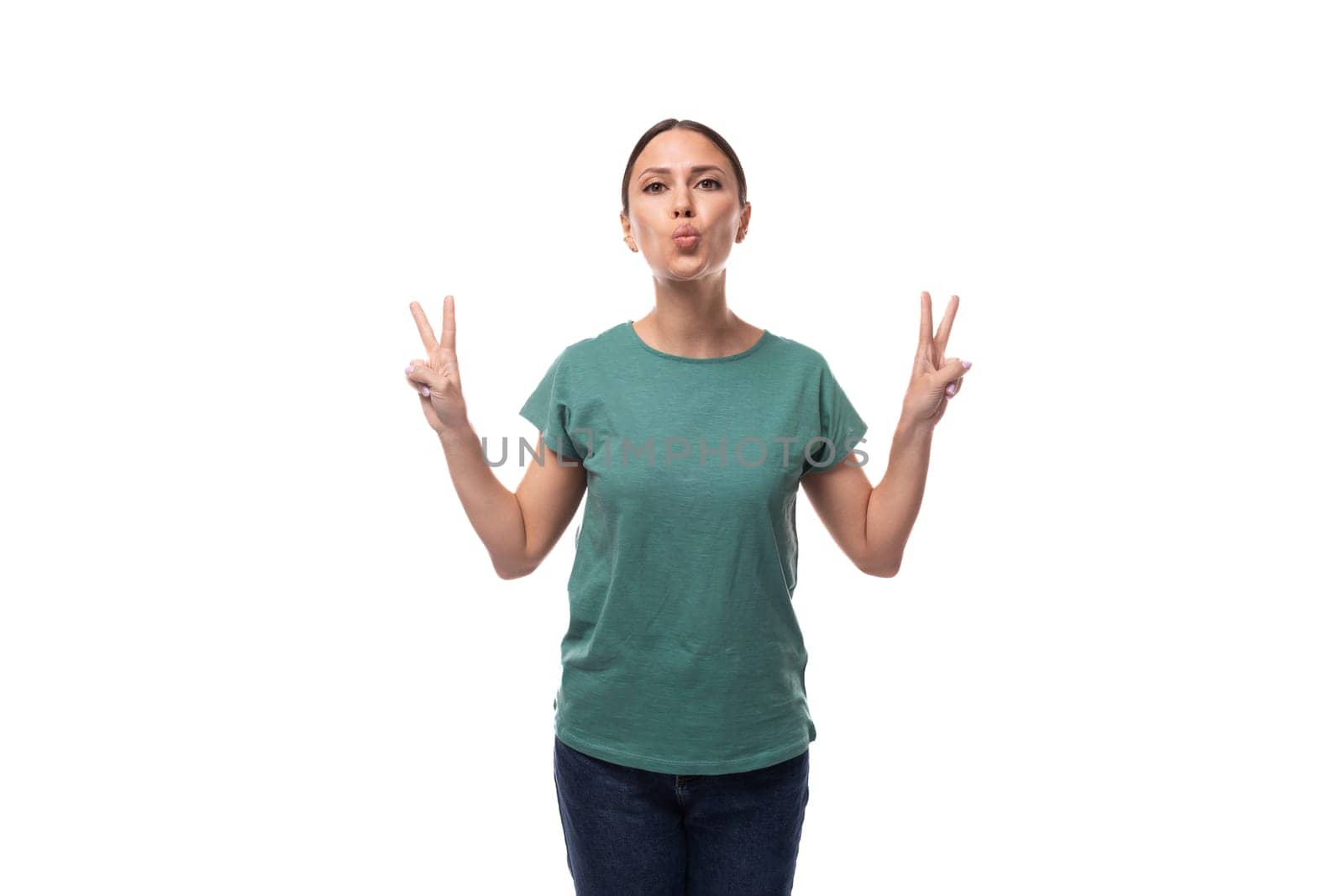 pretty friendly young caucasian brunette woman in green t-shirt on white background with copy space.