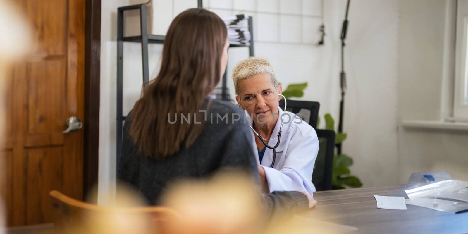 doctor discussion results or symptoms and gives a recommendation to a women patient, giving consultation during medical examination in clinic.