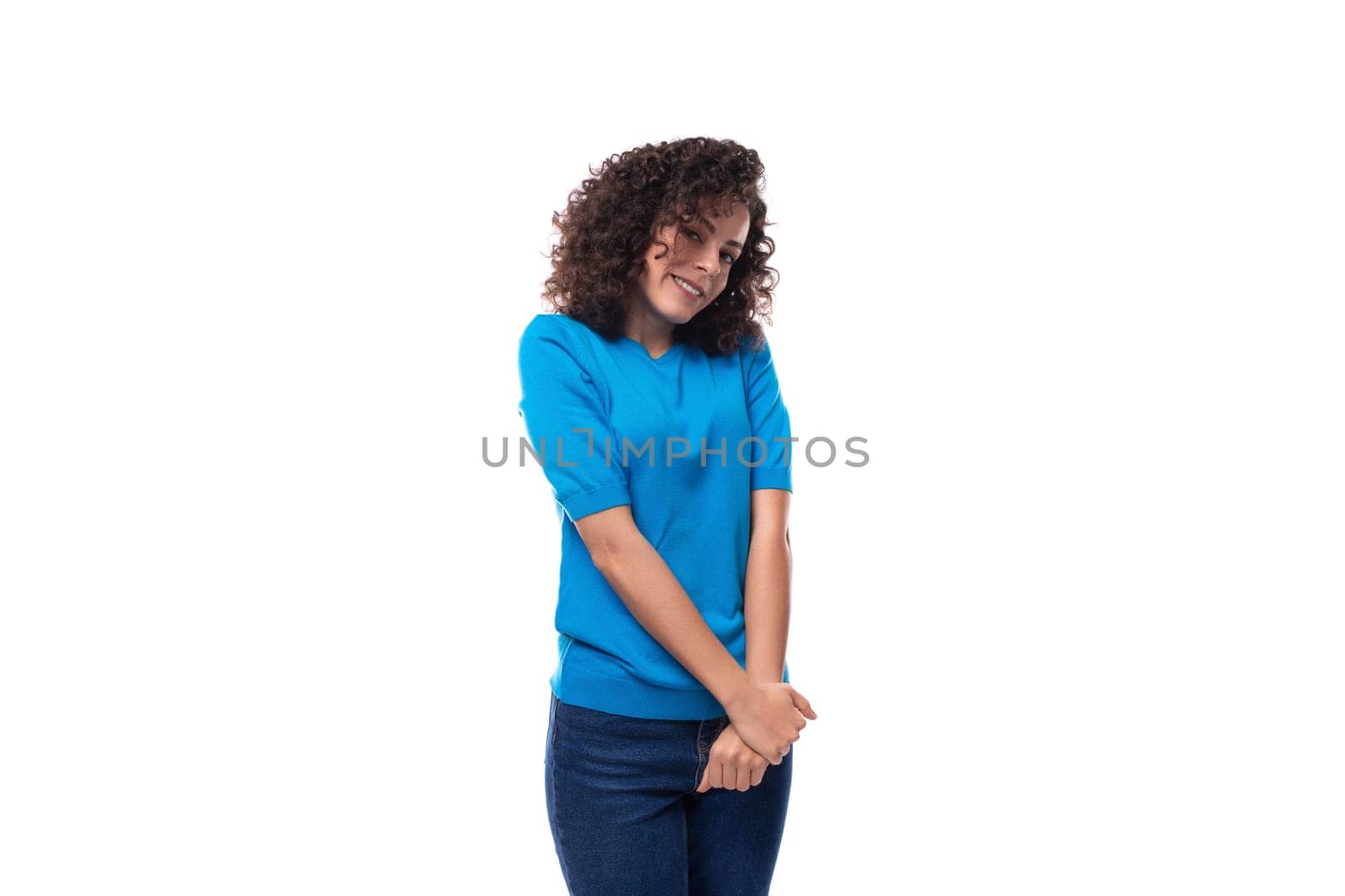 cute young curly brunette woman with shoulder-length hair is wearing a blue t-shirt by TRMK