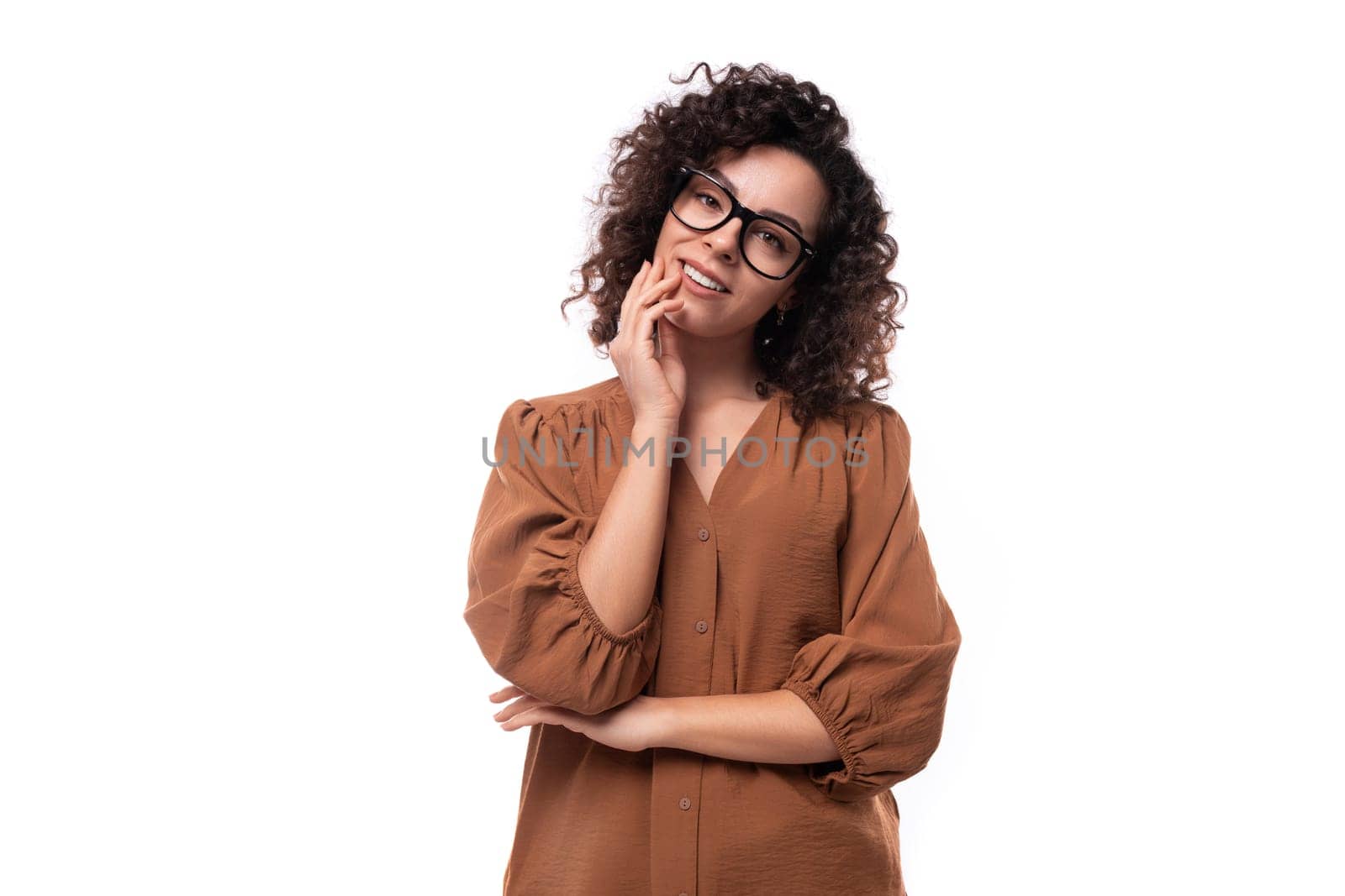 young confident pretty caucasian office worker woman with curly black hair in brown blouse by TRMK