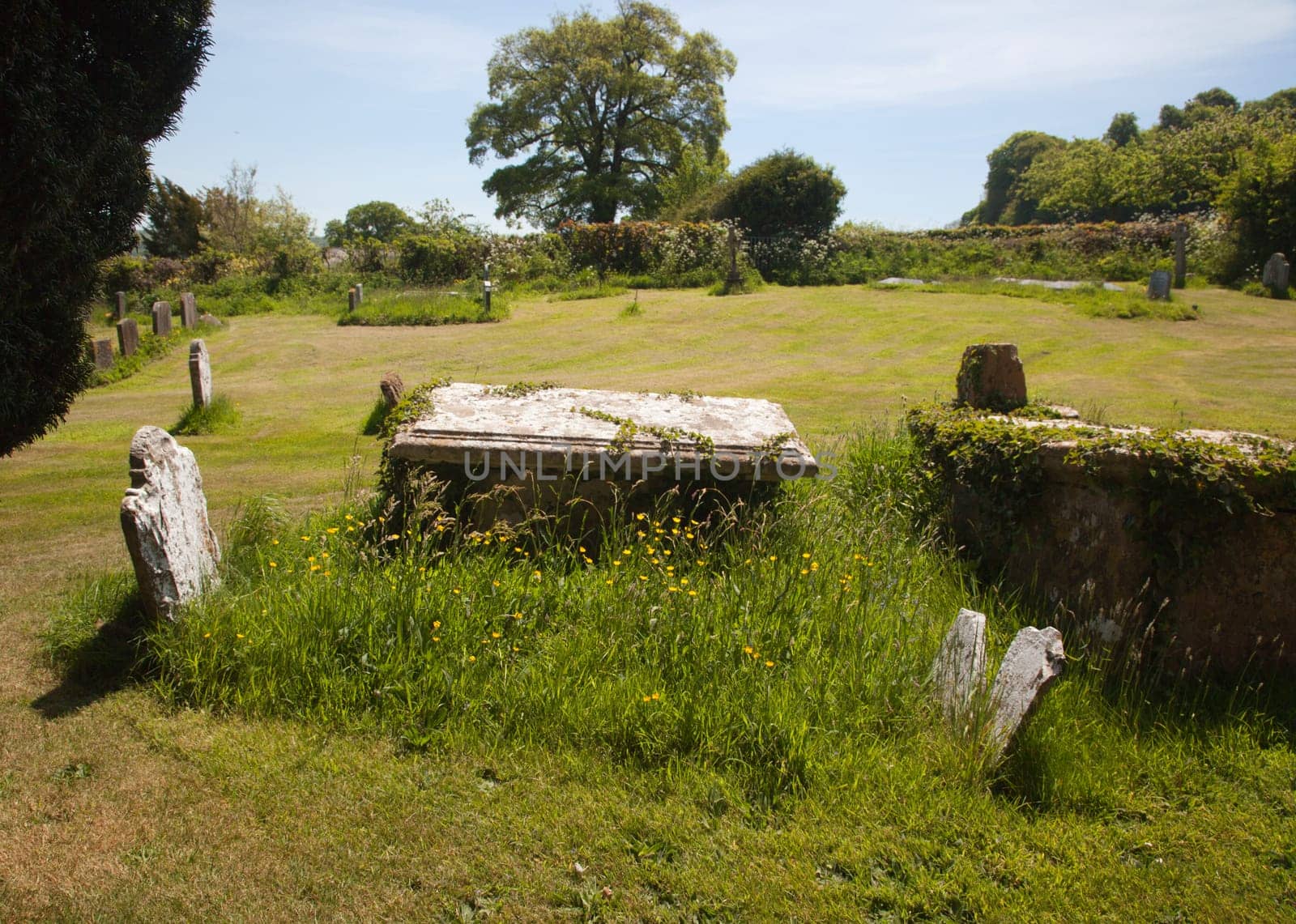 An idyllic and peaceful countryside churchyard graveyard during the summer