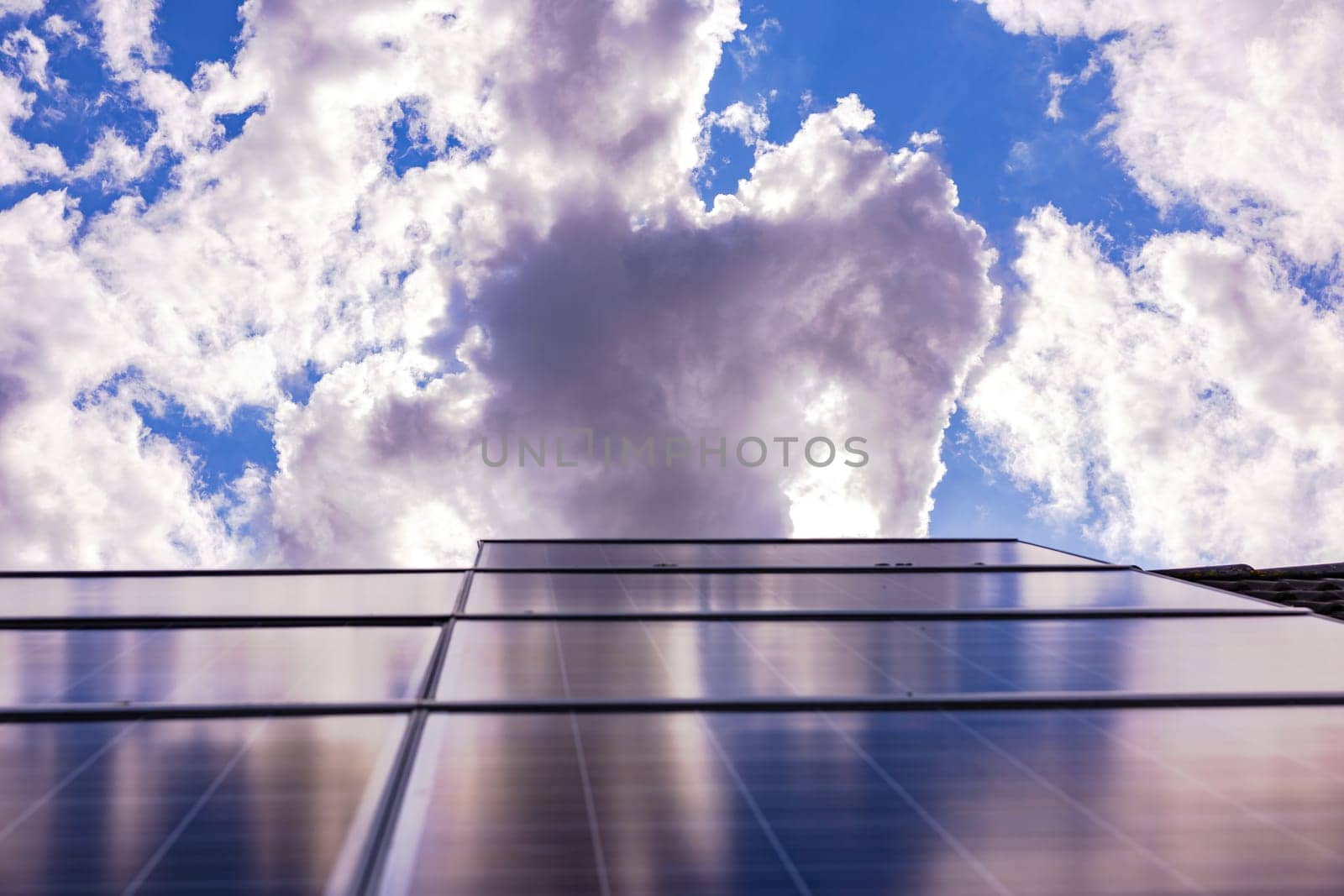 Dark clouds bring shadow on the solar panels of a photovoltaic plant for energy production, Germany