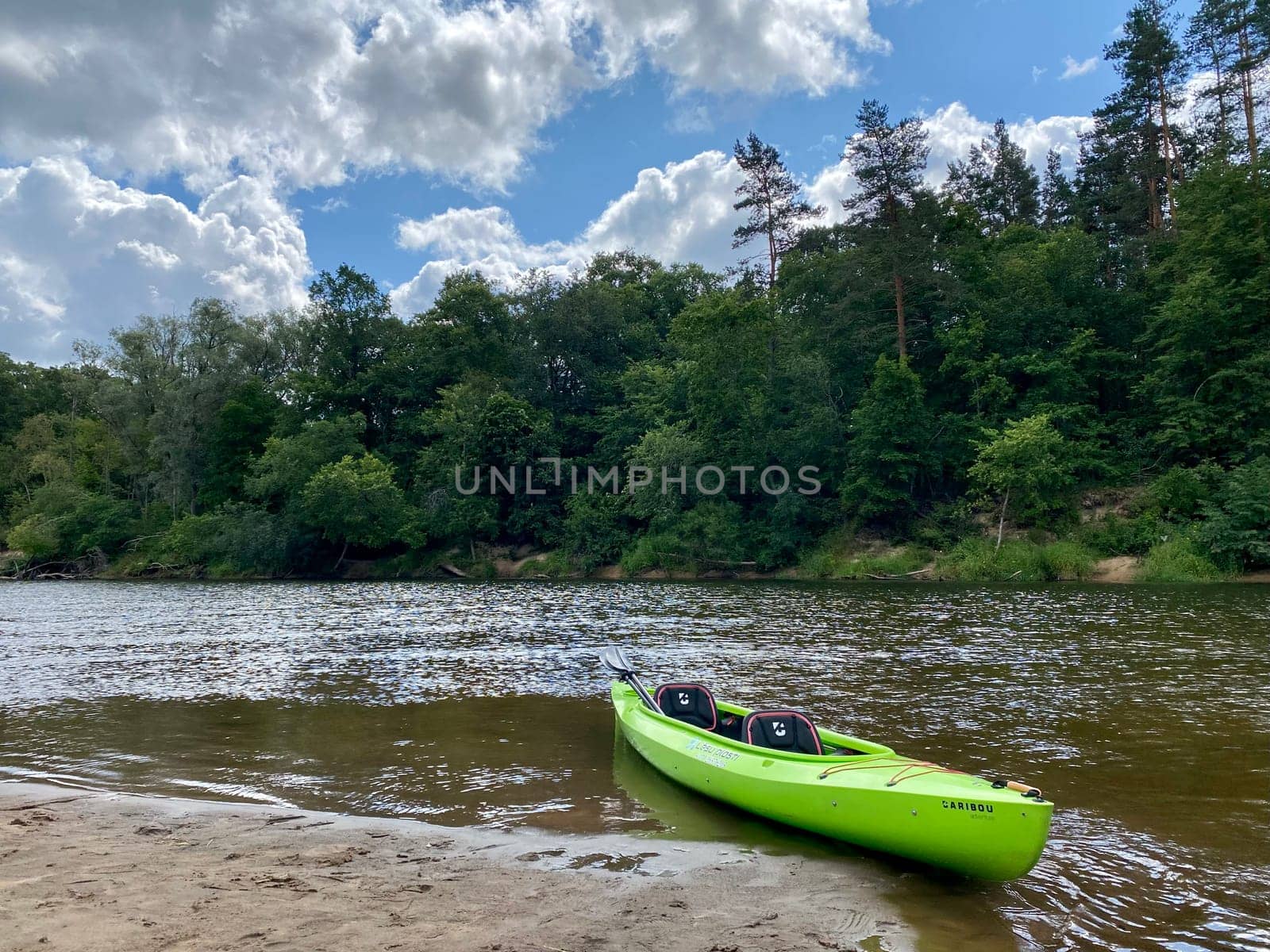 Kayaking on the river Gauja, exploring nature, green kayak boat by DailySF