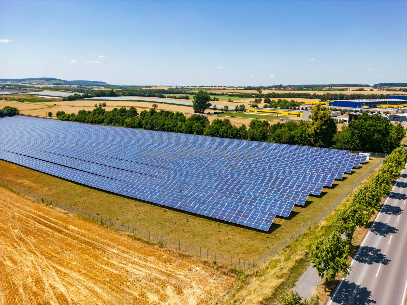 Solar farm with numerous rows of solar panels in a rural area in the south of Germany