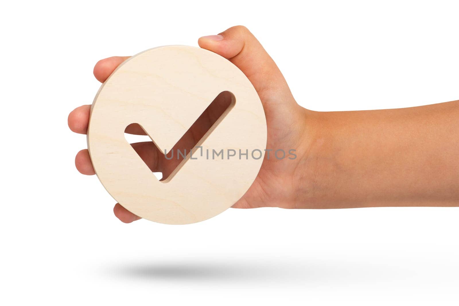 Isolate of hand holding check mark icon on white background. Closeup hand with wooden tick icon, right sign. copy space. Place for text. by SERSOL