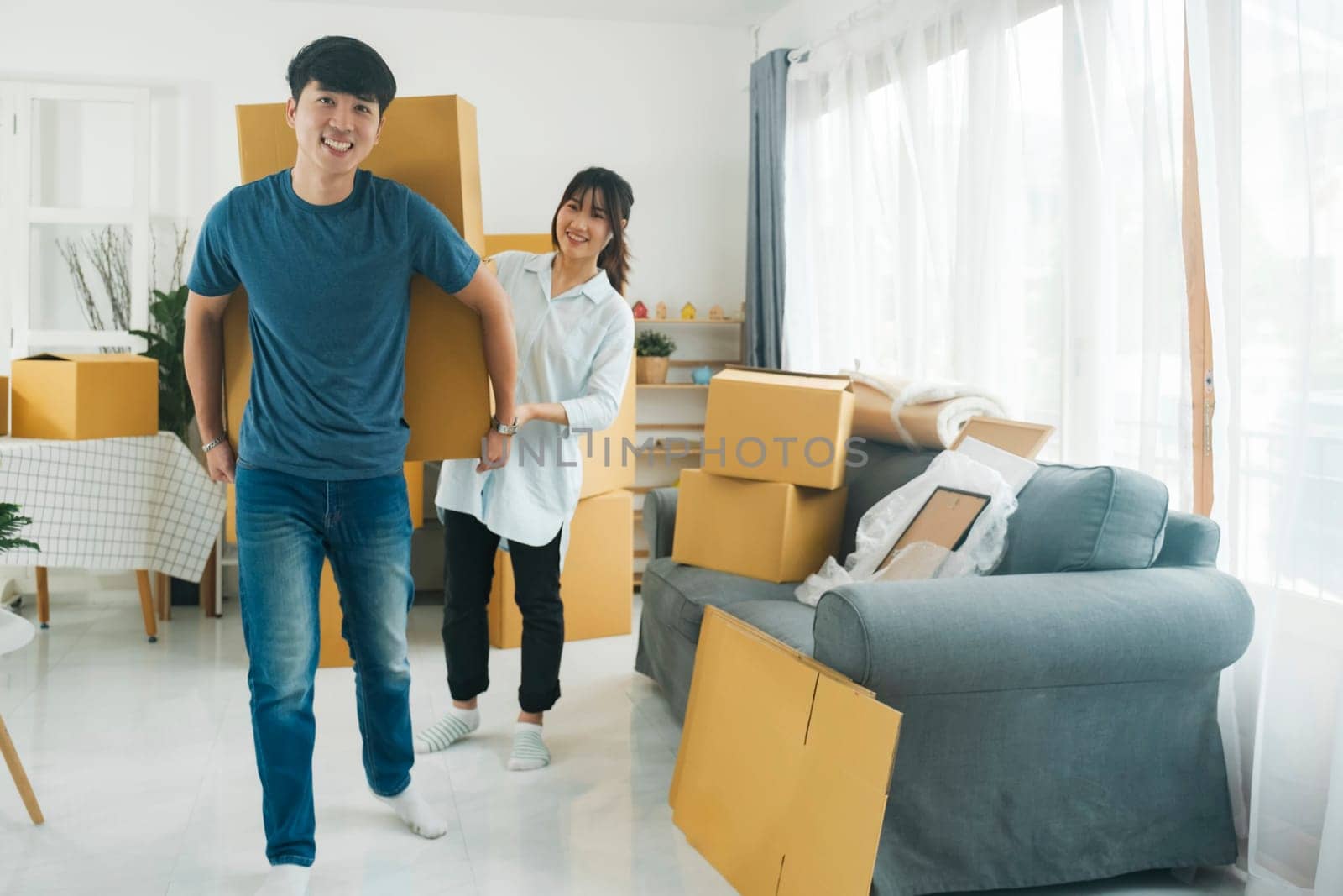 Asian young happy new married couple moving to their new house or real estate. by ijeab