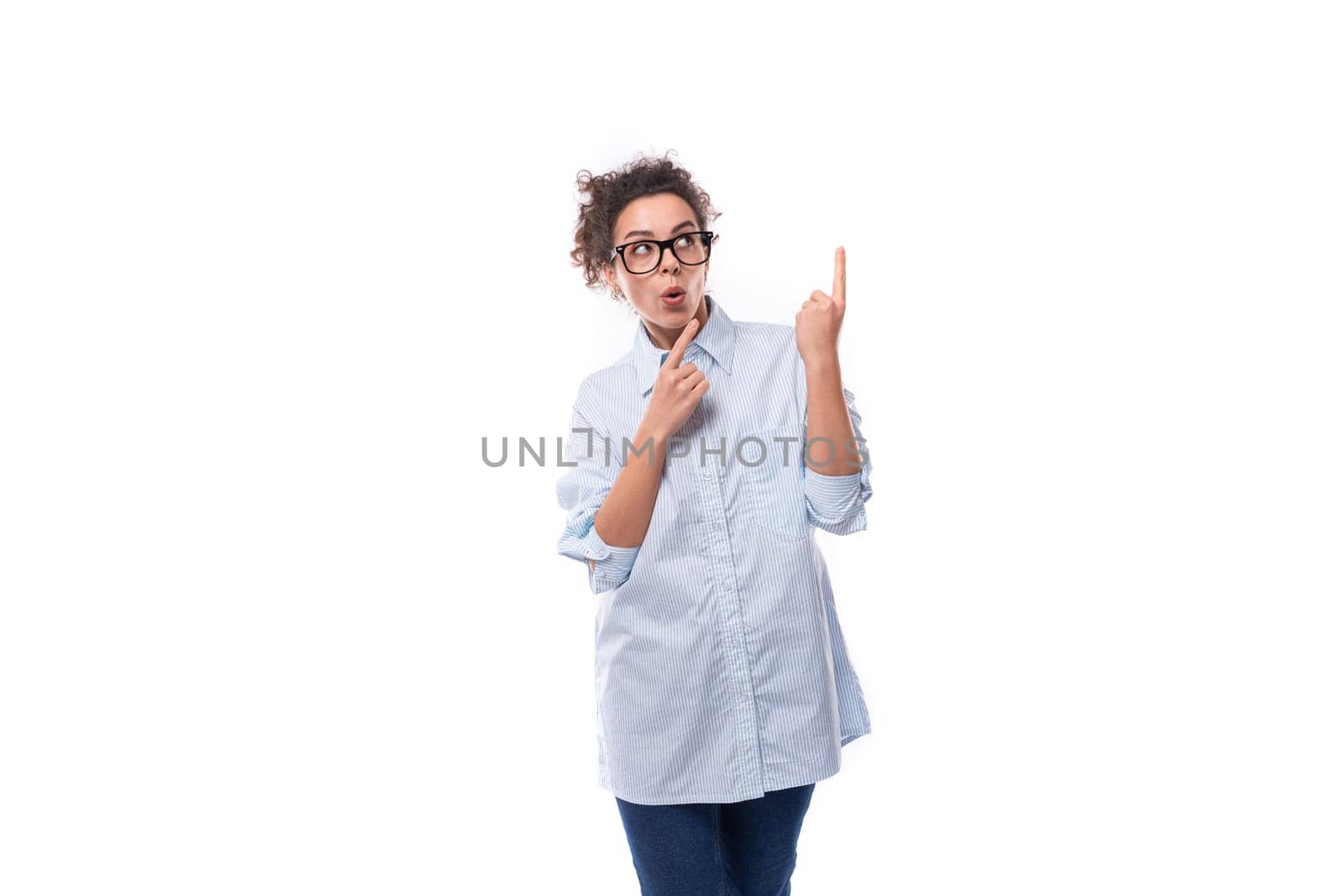 young successful confident leader woman with curly black hair dressed with light blue shirt.