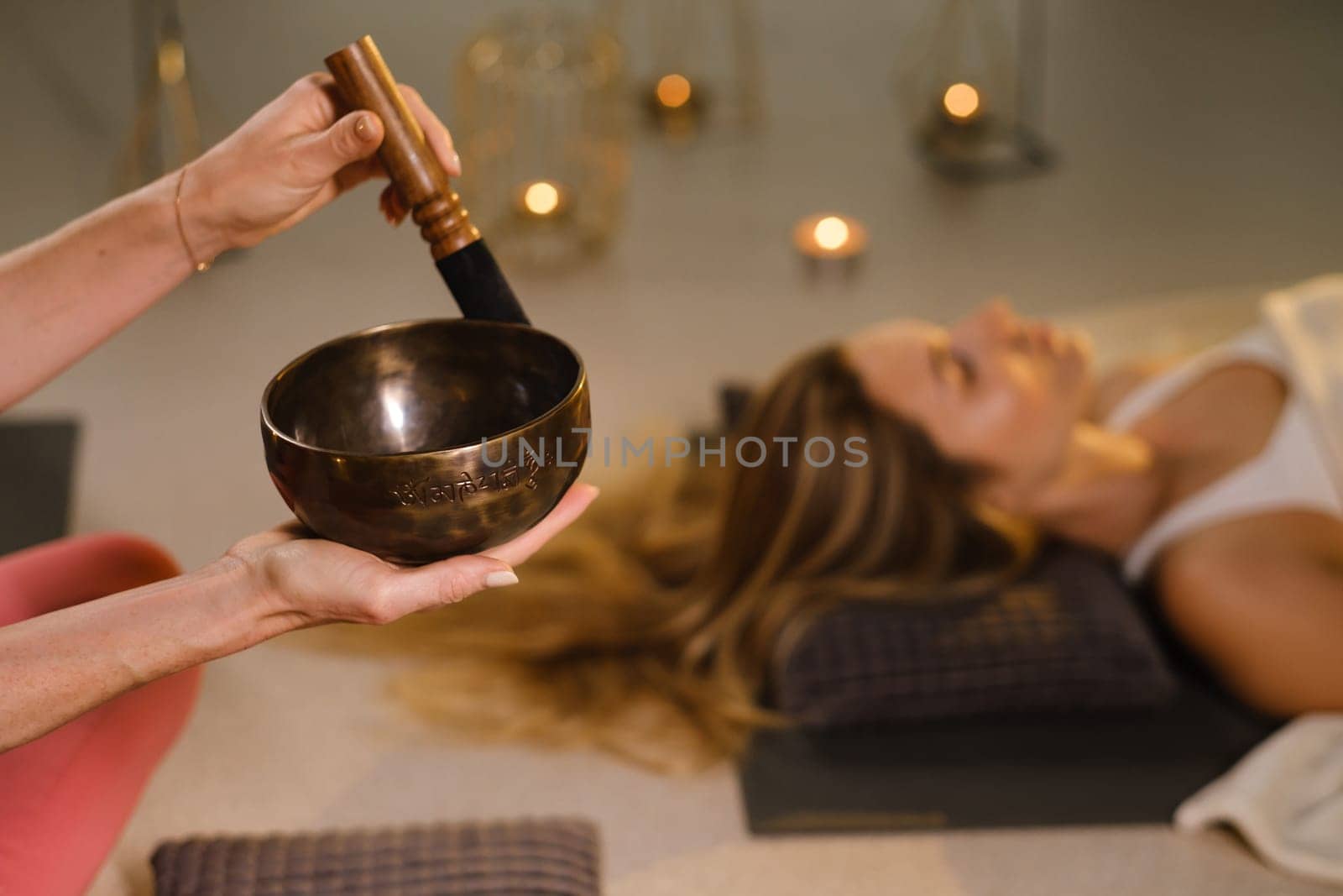 a girl lying on the floor relaxes to the sounds of a Tibetan bowl in the gym by Lobachad