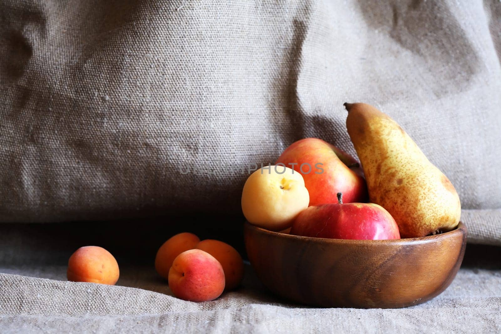 Heap of freshness fruits in  bowl againast nice gray canvas background