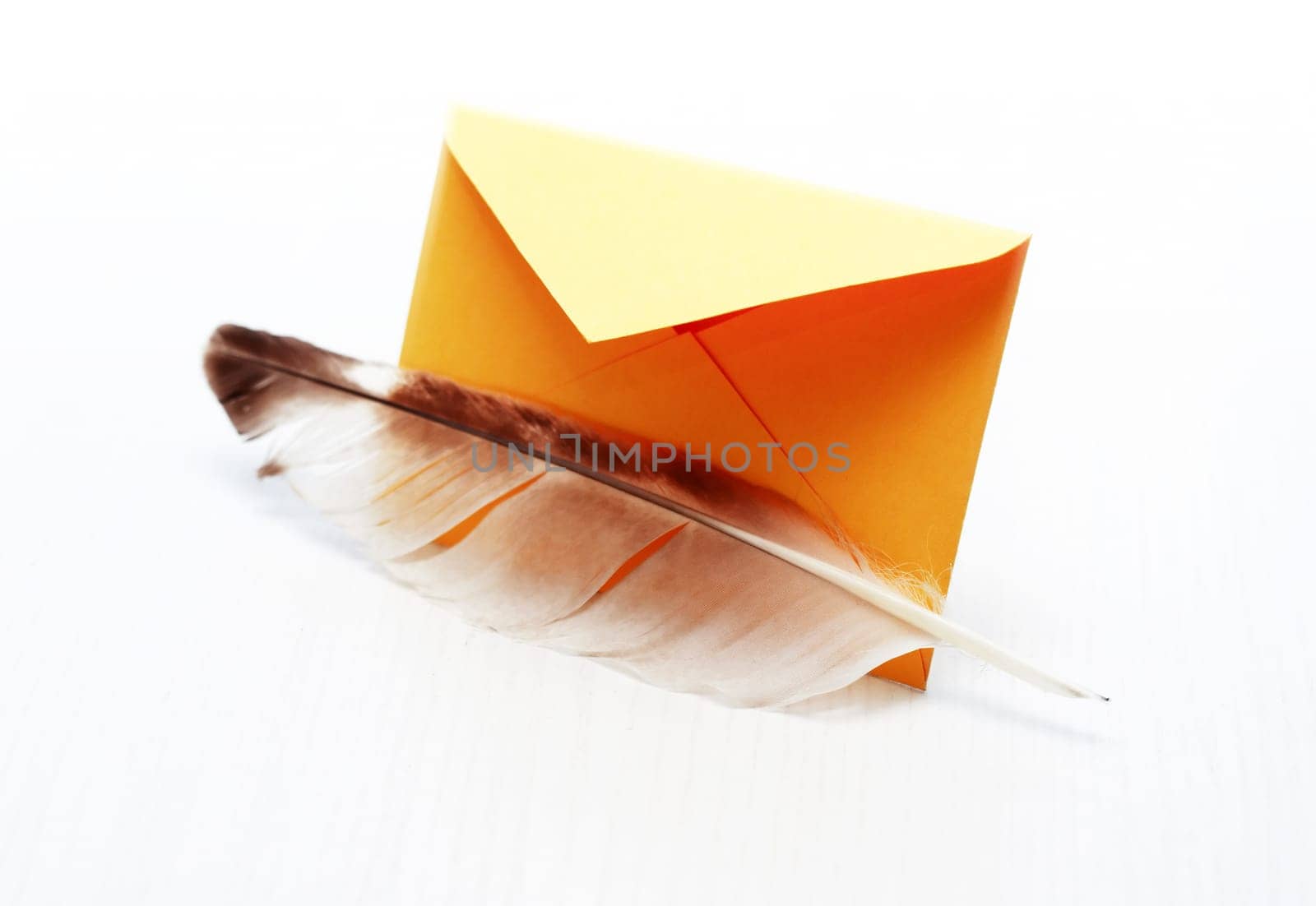 Retro message. Quill pen near yellow envelope on white background
