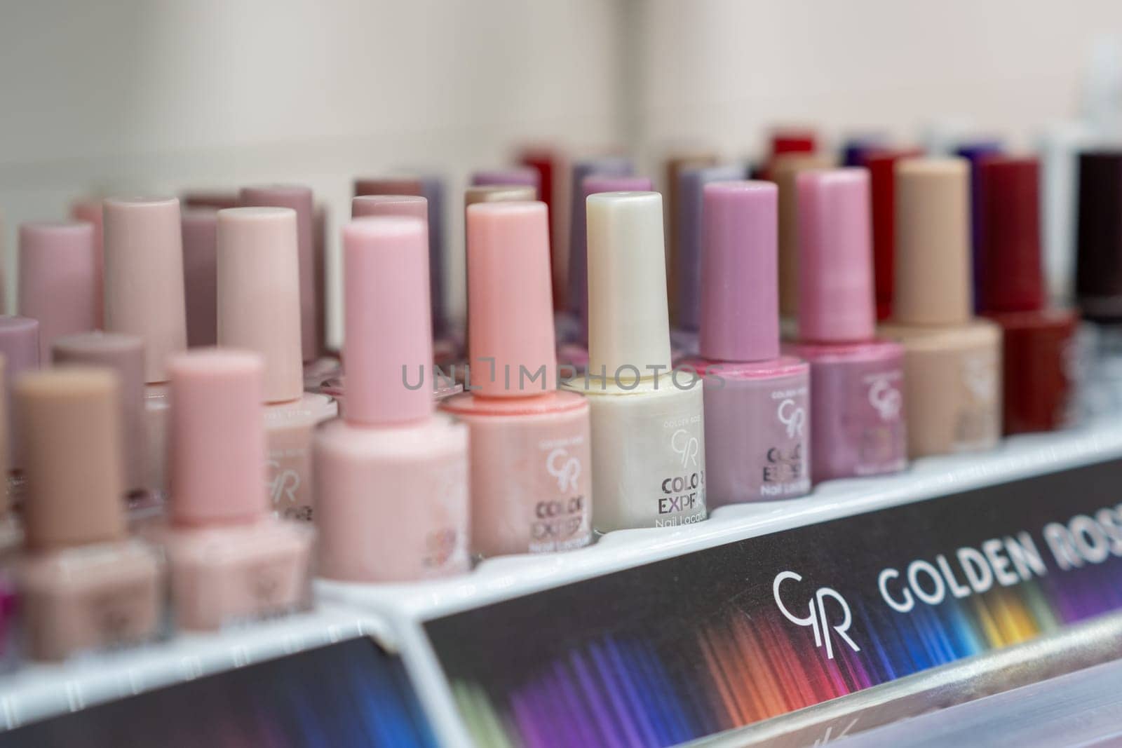 Showcase with different nail polishes in a store window. by AnatoliiFoto