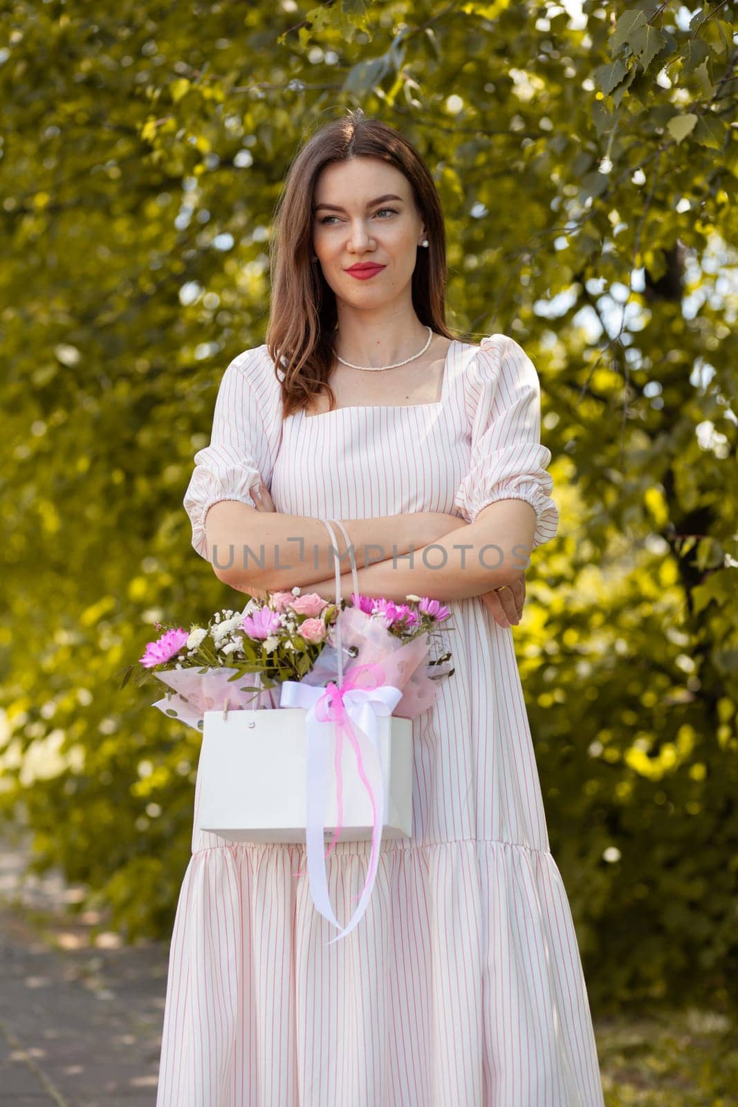 Beautiful girl with flowers, in a dress, glasses and sneakers. by AnatoliiFoto