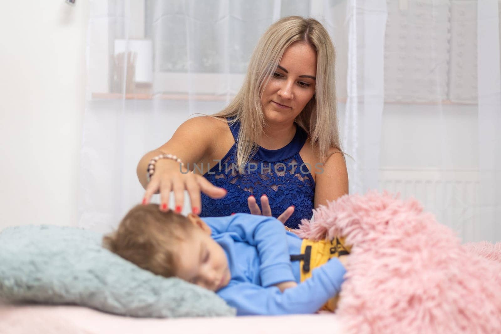 Process of access or consciousness bars therapy, woman healing an young boy by method of 32 points on the head that we touch lightly in certain combinations, an alternative medicine by Kadula