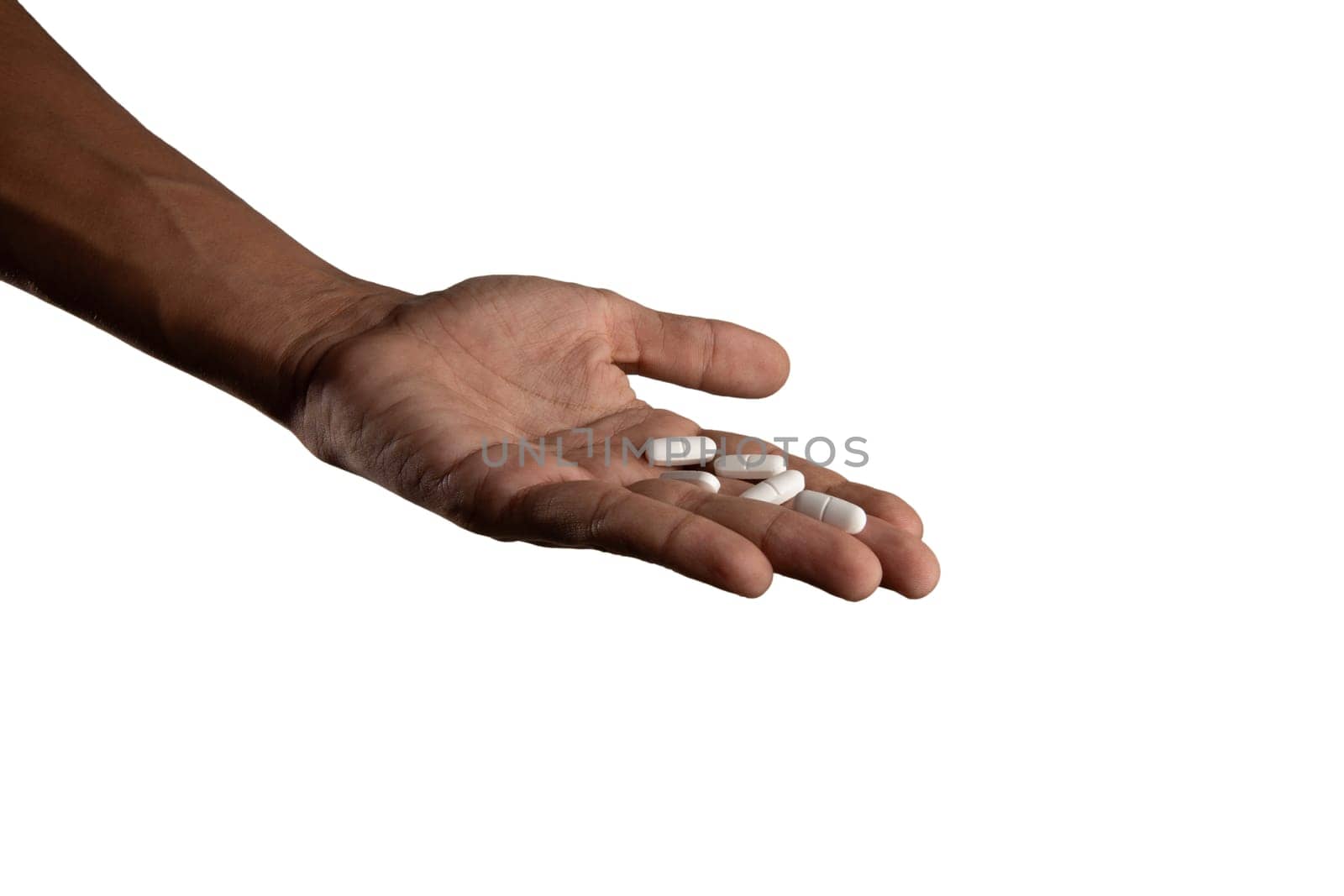 Black male hand holding pills isolated mental health concept by TropicalNinjaStudio