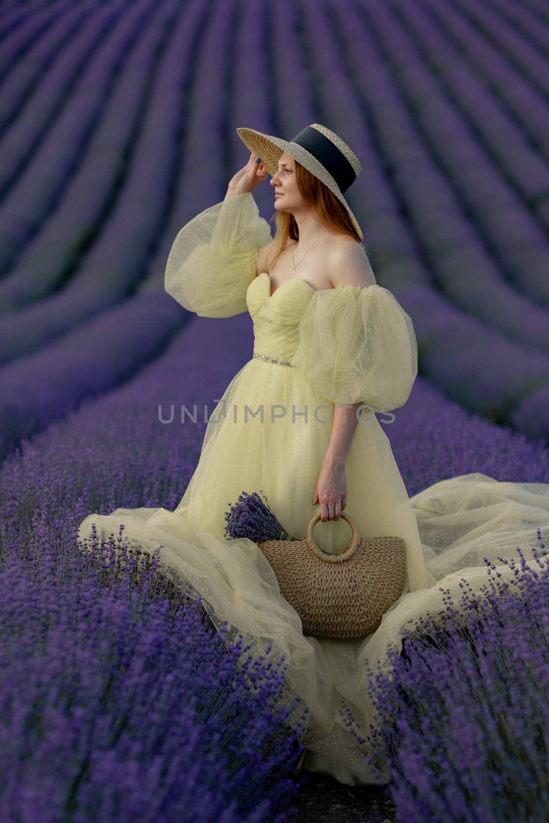 Lavender field happy woman in yellow dress in lavender field summer time at sunset.