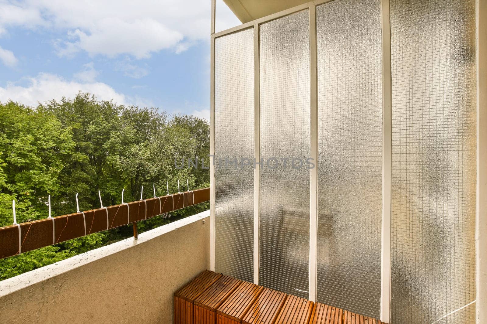 a balcony with a large glass shower and a bench by casamedia