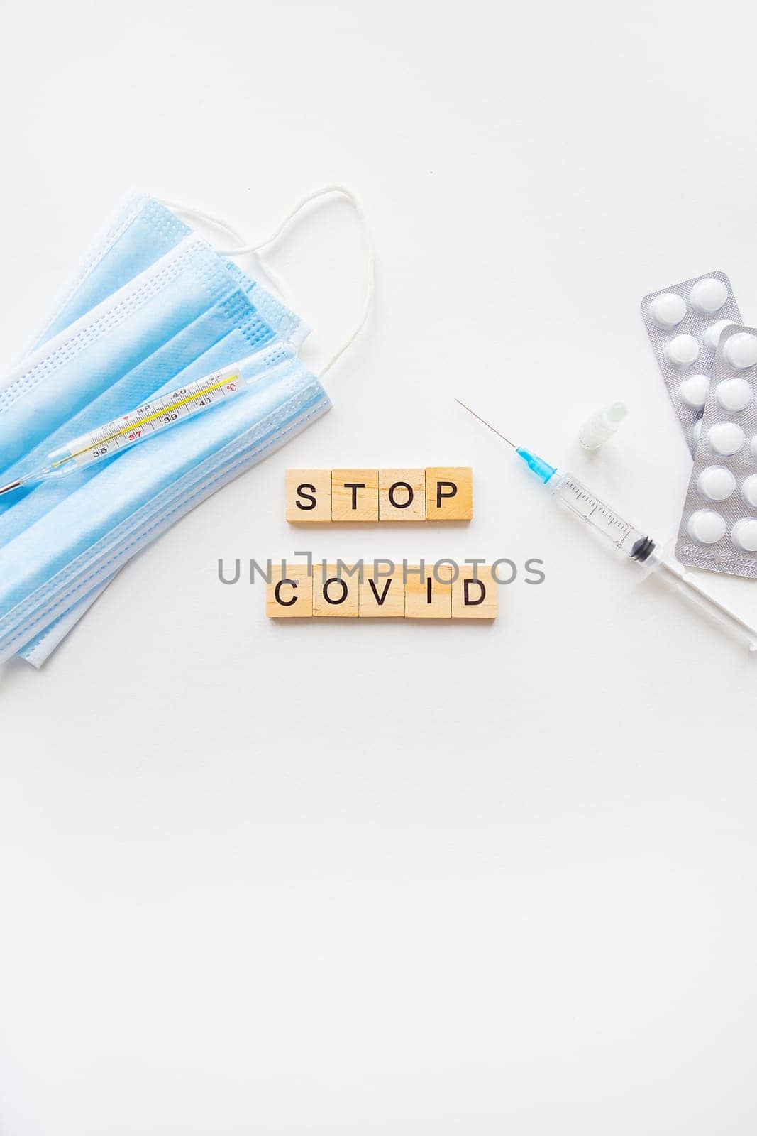 Stop coronavirus inscription. A new strain of coronavirus-omicron, pyrola. Preparing for vaccination against covid. Syringe, vaccine, pills, medical mask