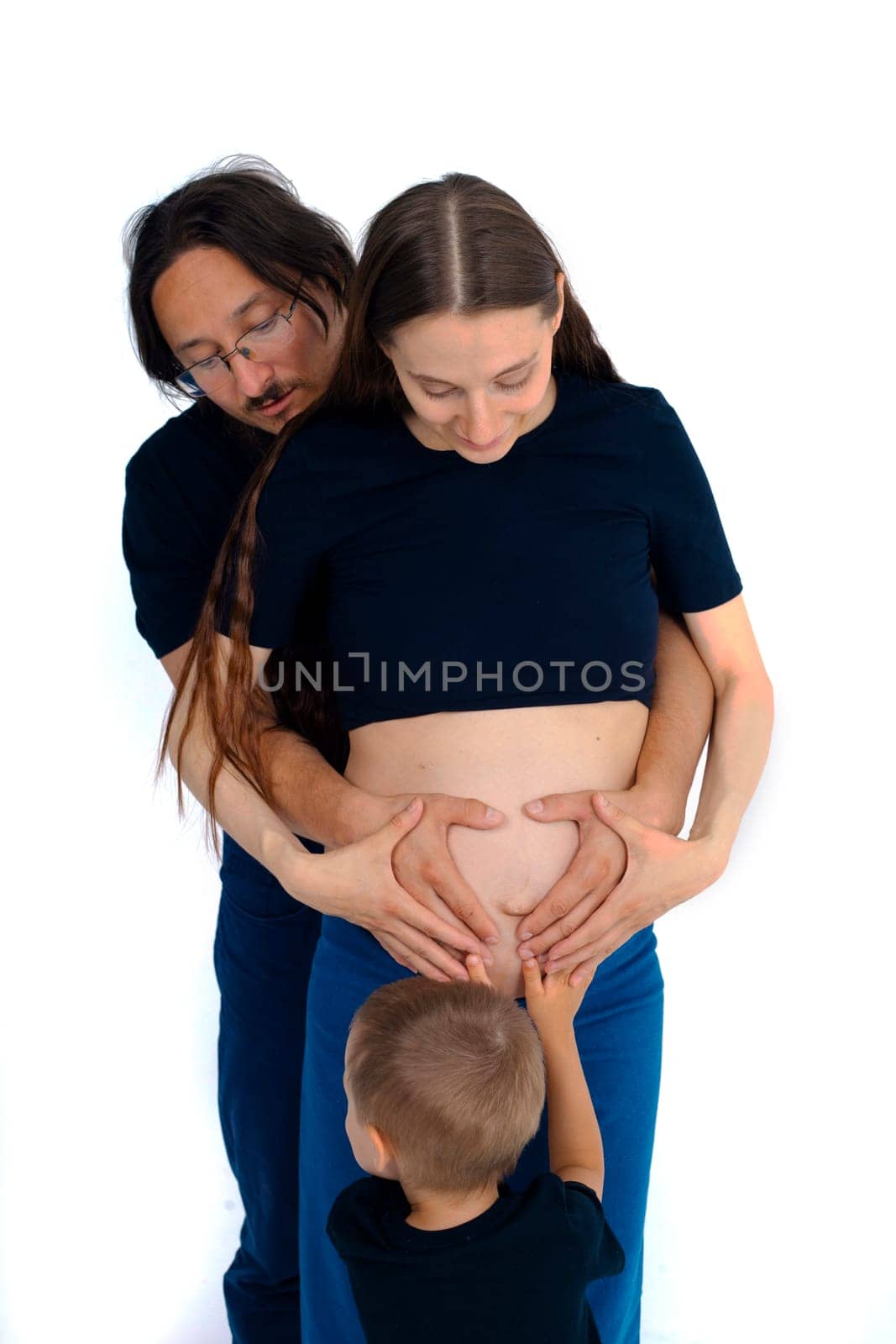 Beautiful pregnant woman with her family on white background by kajasja