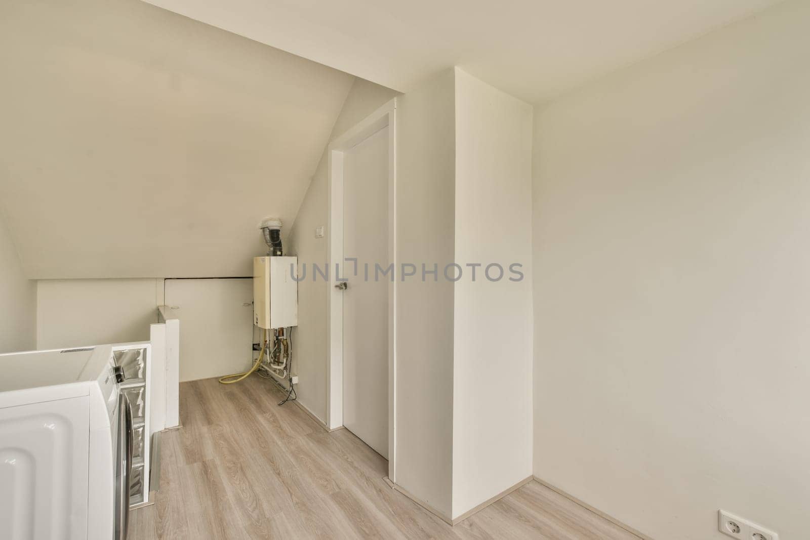 a living room with white walls and a wood floor by casamedia