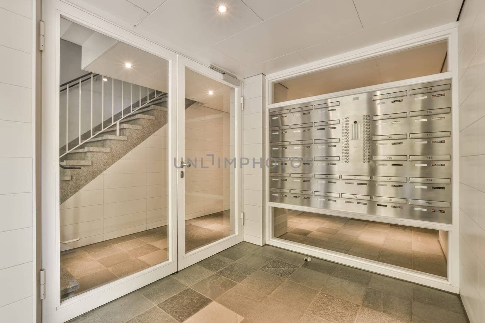 a wine cellar with glass doors and a staircase by casamedia