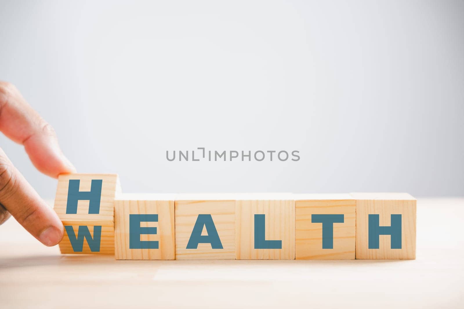 Tabletop cube flip Wealth to Health. Money turned into health concept. Medical investment for a secure future. Wellness healthcare