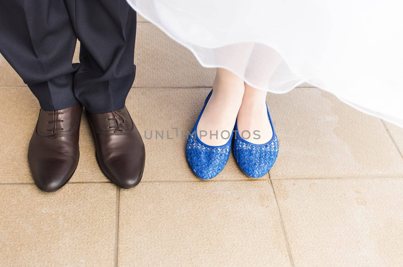 feet of bride and groom, wedding shoes close-up.