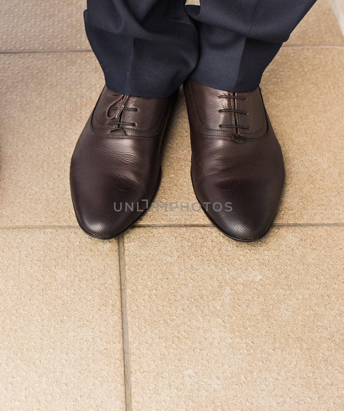 Close-up of businessman feet in black boots on the floor. by Satura86