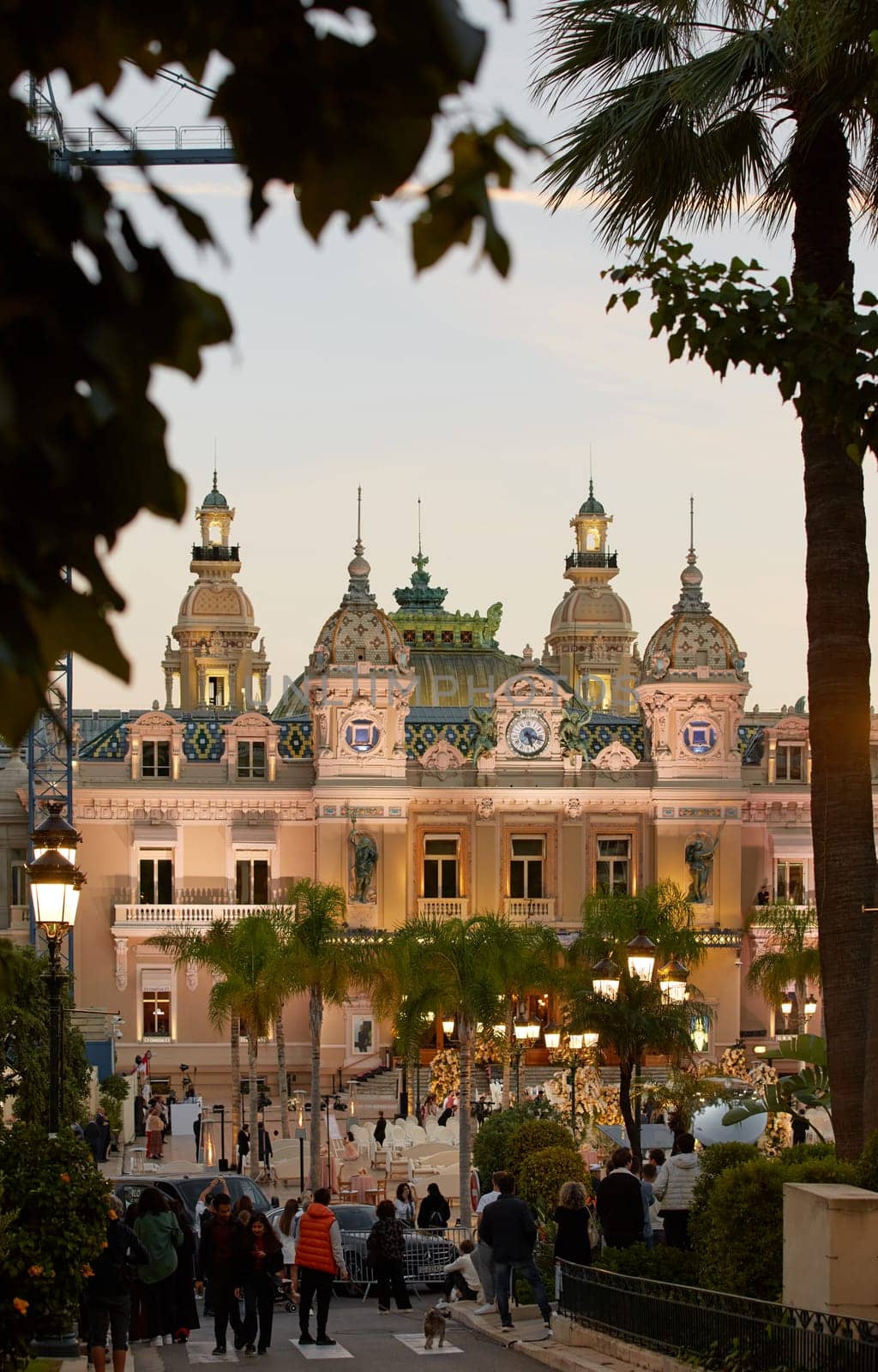 Monaco, Monte-Carlo, 21 October 2022: Square Casino Monte-Carlo at sunny day, a lot of luxury cars, Hotel de Paris, wealth life, tourists take pictures of the landmark, pine trees, blue sky, flowers. High quality 4k footage