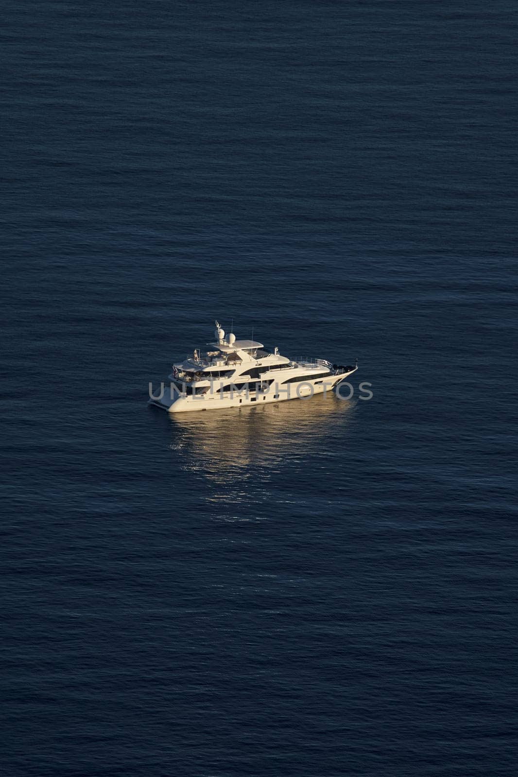 Monaco, lonely mega yacht in sea at sunset, huge motor boat, wealth life of billionaires . High quality photo