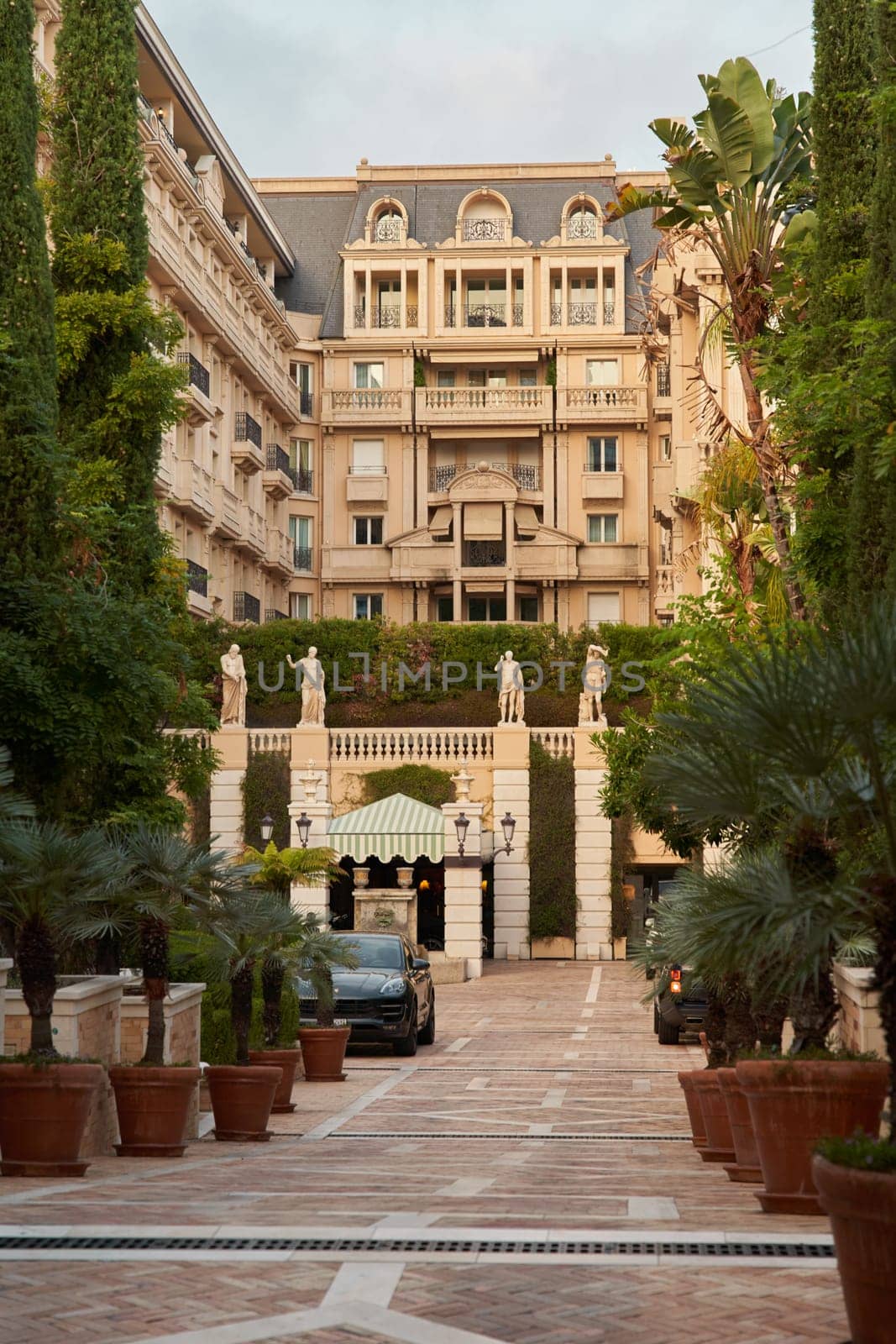 Monaco, Monte-Carlo, 26 October 2022: Shop mall gallery Metropole, famous hotel at sunset, luxury cars. High quality photo