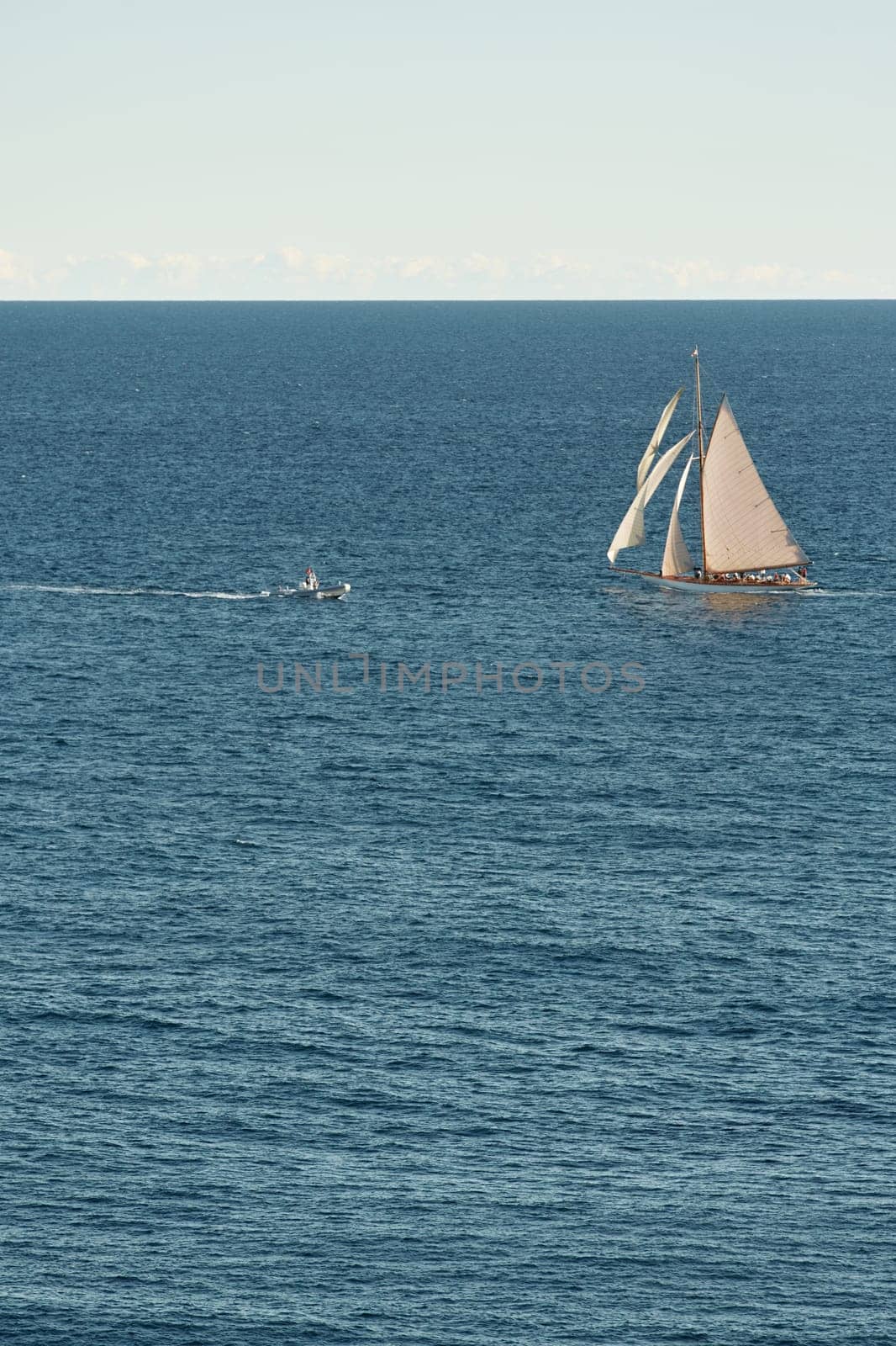 Monaco, lonely vintage sail yacht in sea at sunset, huge sail boat, wealth life of billionaires . High quality photo