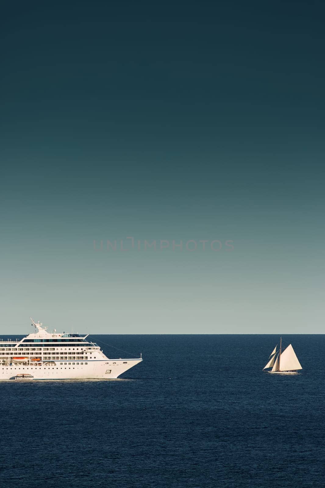 Monaco, vintage sail yacht and huge cruise liner are in sea at sunset, huge motor ship, wealth life of billionaires . High quality photo