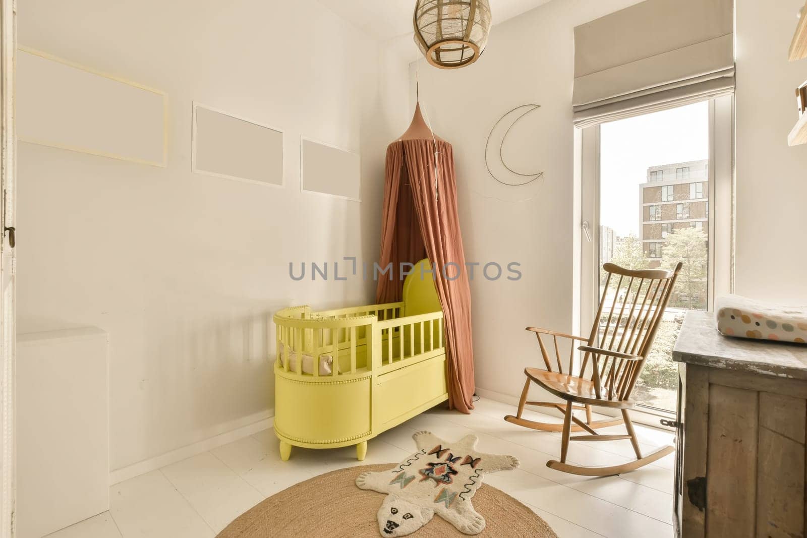 a baby room with a crib and a rocking chair by casamedia