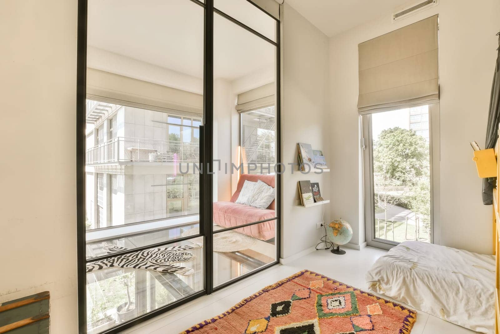 a bedroom with a bed and a large glass window by casamedia