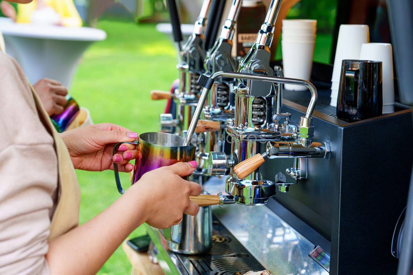 Barista Making Tasty Coffee on a Professional Machine Installed in the Backside of a Minivan by PhotoTime