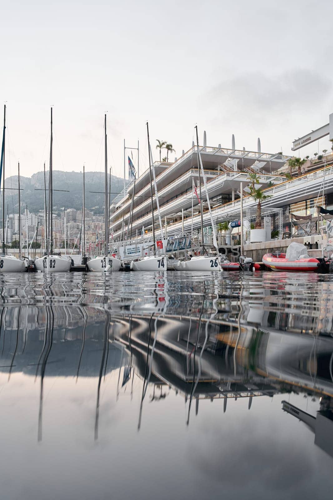 Monaco, Monte-Carlo, 18 October 2022: A lot of sailing boats are moored in new Yacht Club at the world championship of J70 class at sunset, port Hercules. High quality photo