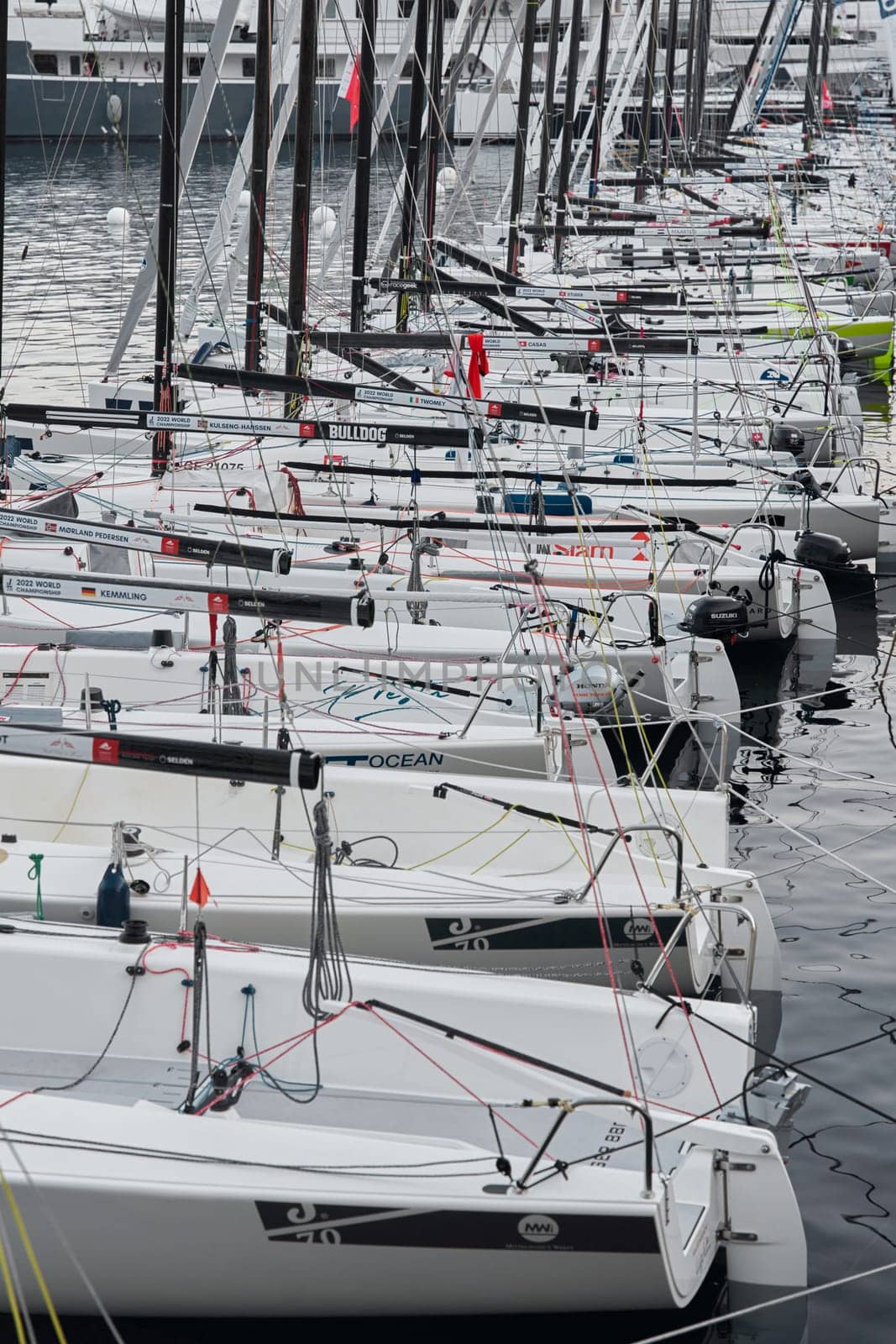 Monaco, Monte-Carlo, 18 October 2022: A lot of sailing boats are moored in new Yacht Club at the world championship of J70 class at sunset, port Hercules. High quality photo